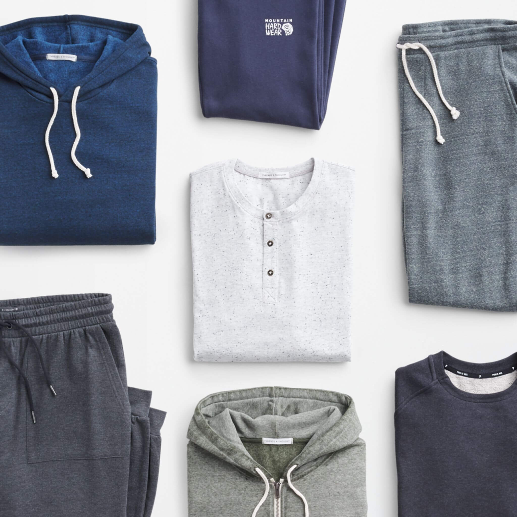 Stitch Fix Men’s outfit laydown featuring a navy hoodie, navy sweatpants, grey joggers, navy pullover sweatshirt, front-zip hoodie and navy joggers. 