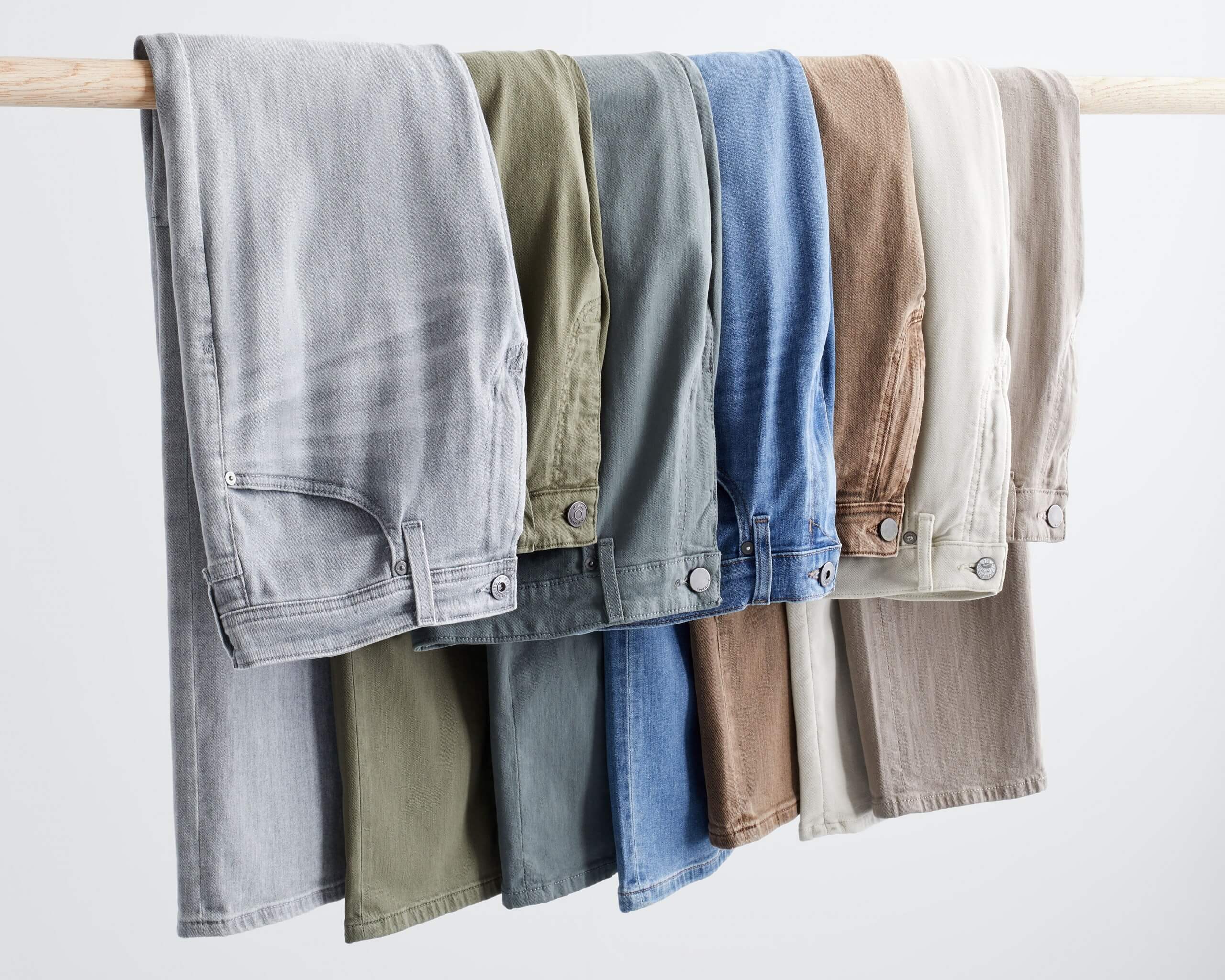 Stitch Fix rack image of grey jeans, green jeans, blue jeans, and brown jeans.