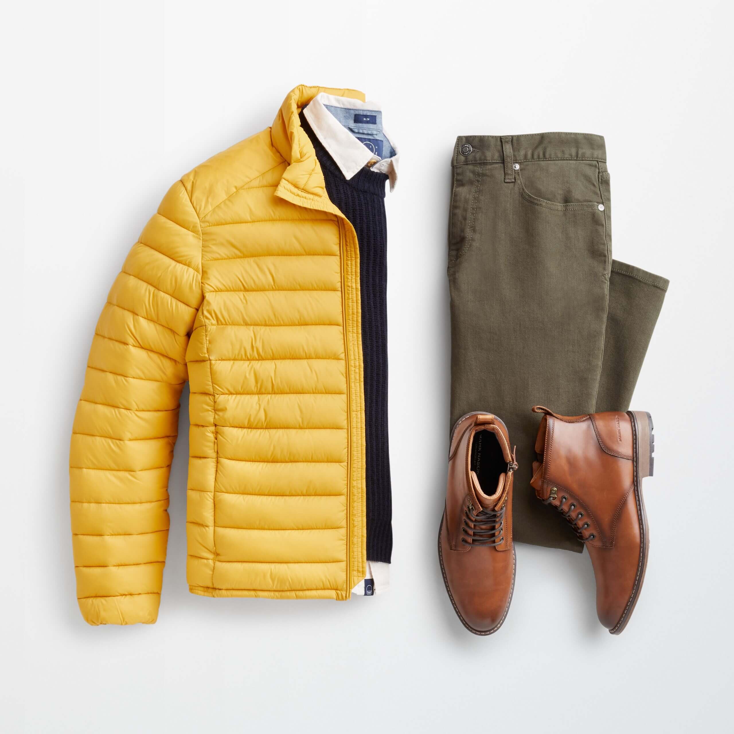 Stitch Fix men's outfit laydown featuring yellow puffer jacket over blue pullover and collared shirt, olive jeans and brown leather boots. 