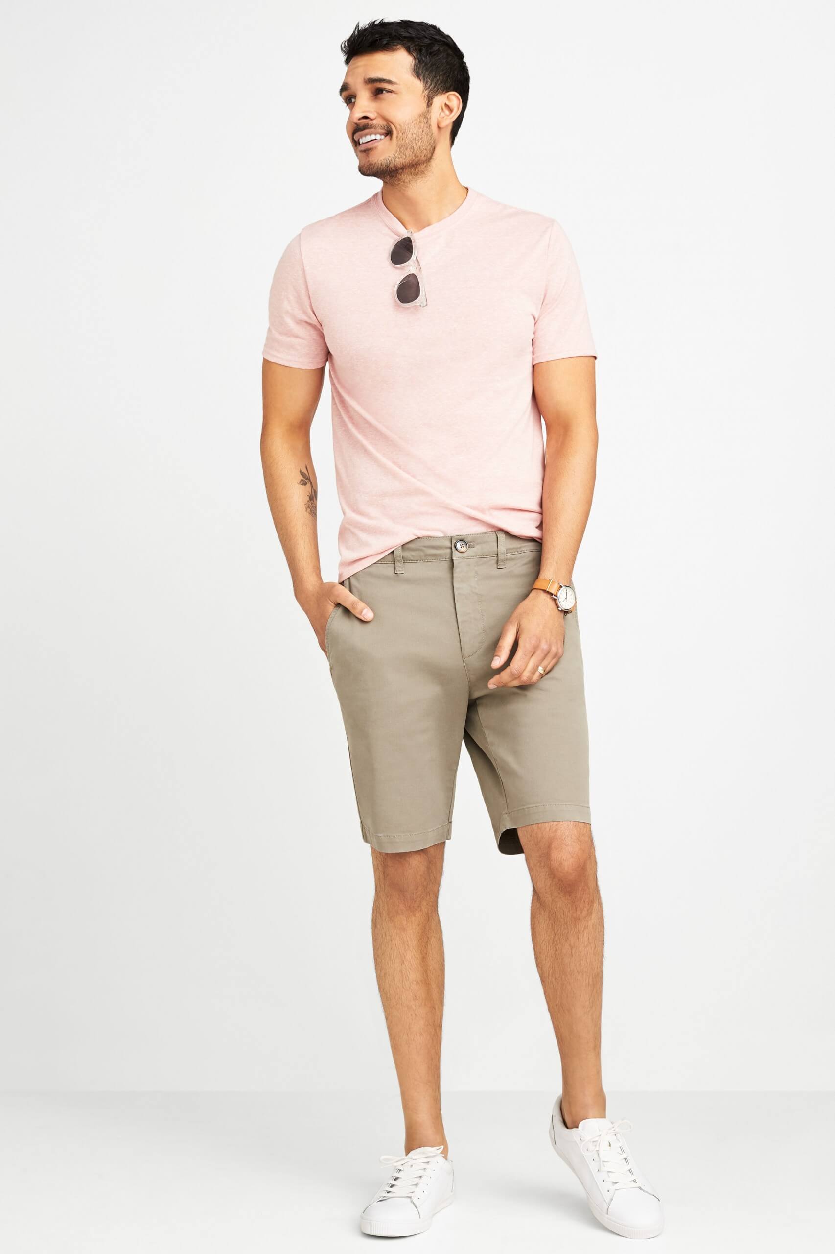 Stitch Fix Men's model wearing pink crew neck t-shirt, khaki shorts and white leather sneakers.