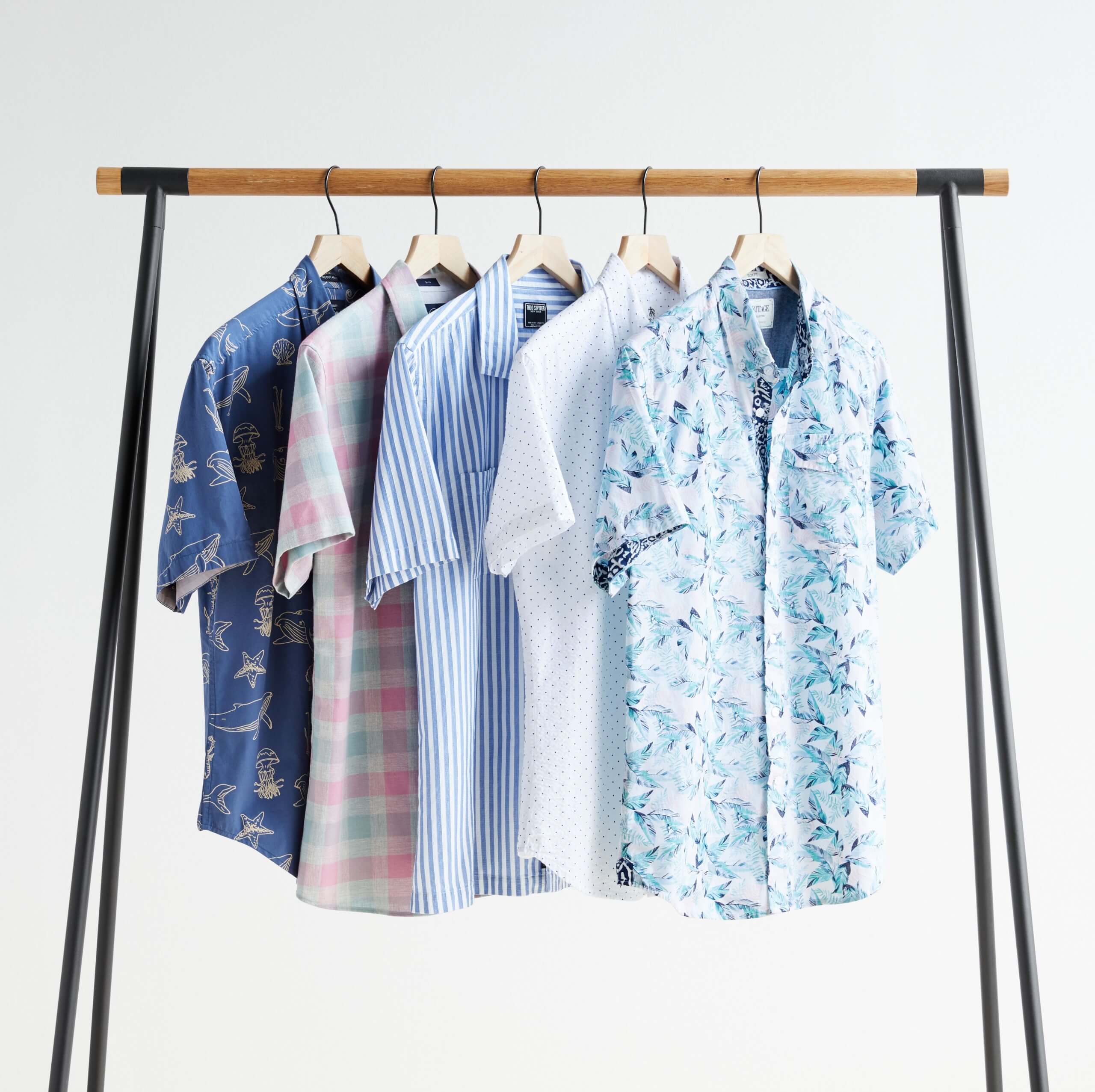 Stitch Fix Men’s rack image with patterned short-sleeved button-down shirts in blue, white and pink. 