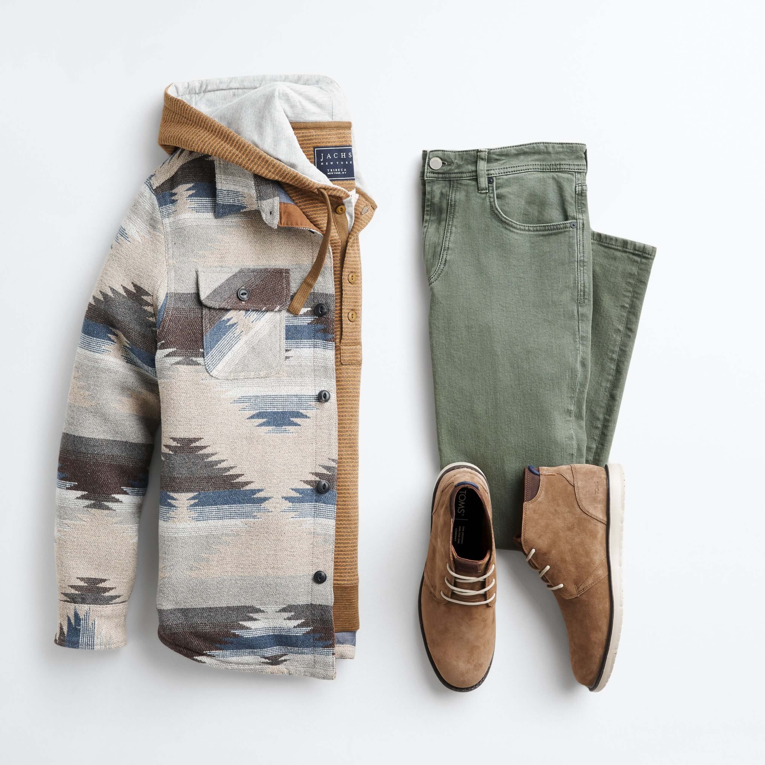 Stitch Fix Men’s outfit laydown featuring aztec shirt jacket over brown hoodie, next to olive jeans and brown chukkas. 