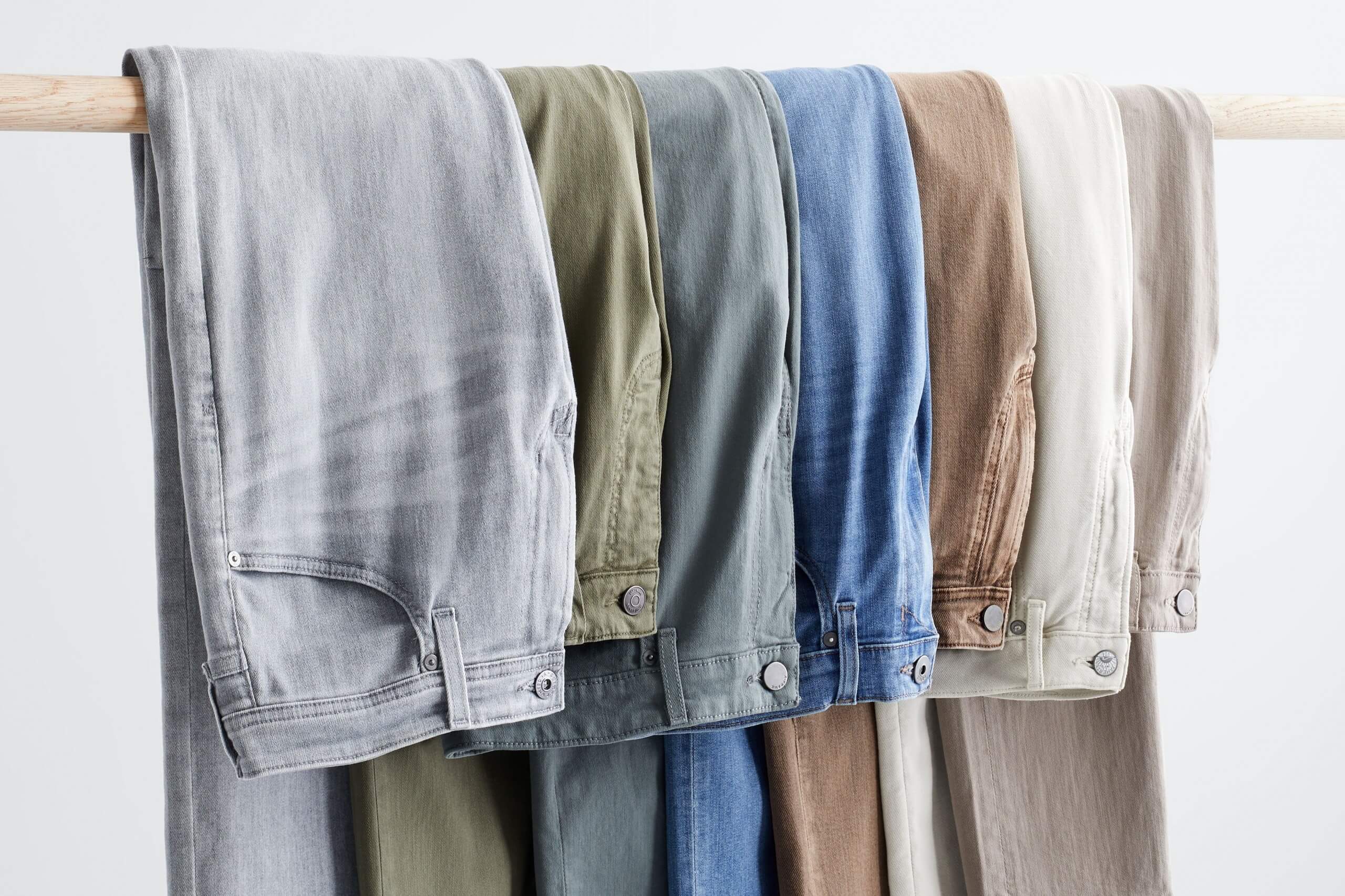 Stitch Fix rack image of grey jeans, green jeans, blue jeans, and brown jeans.