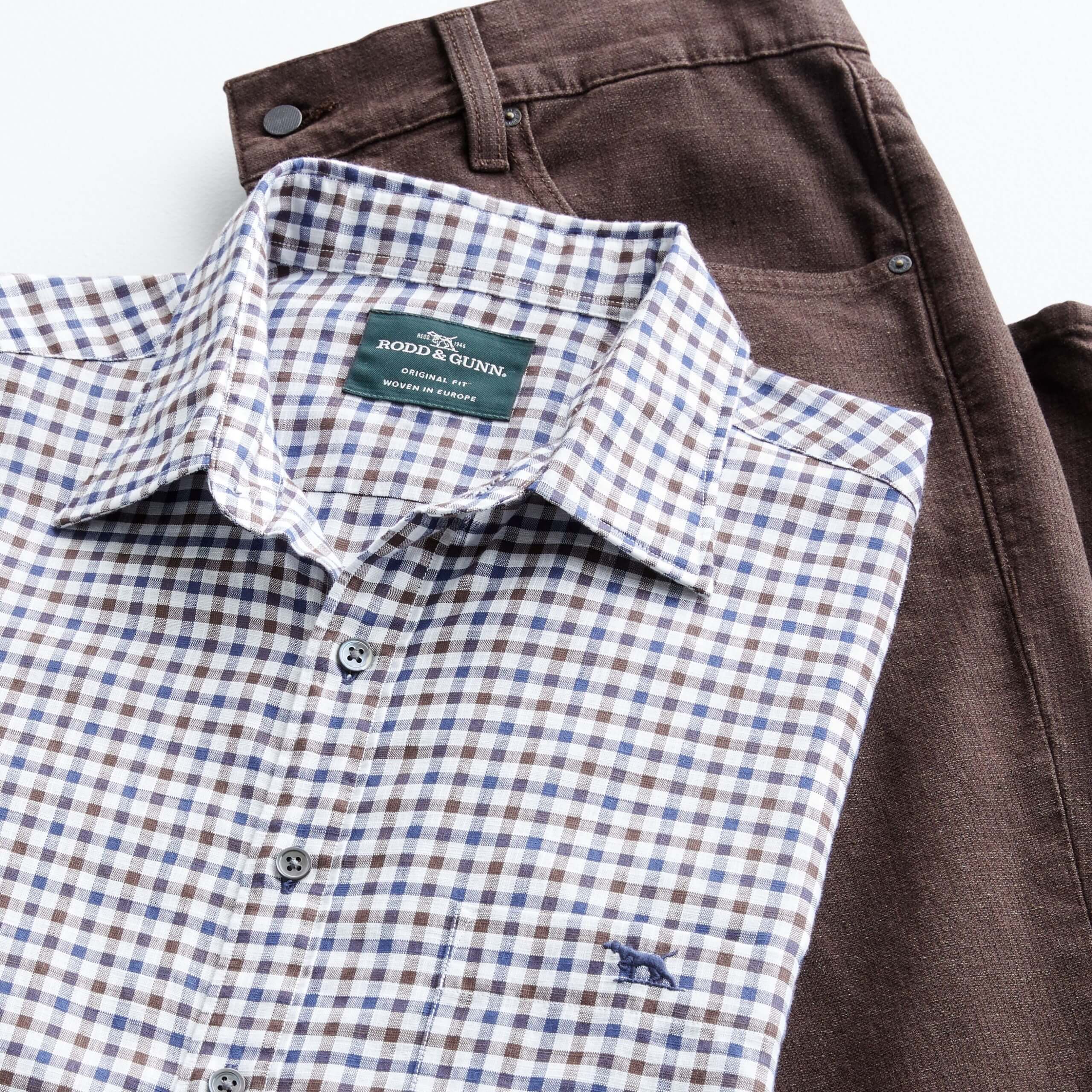 Stitch Fix Men’s outfit laydown featuring white, blue and brown check woven shirt and brown pants. 