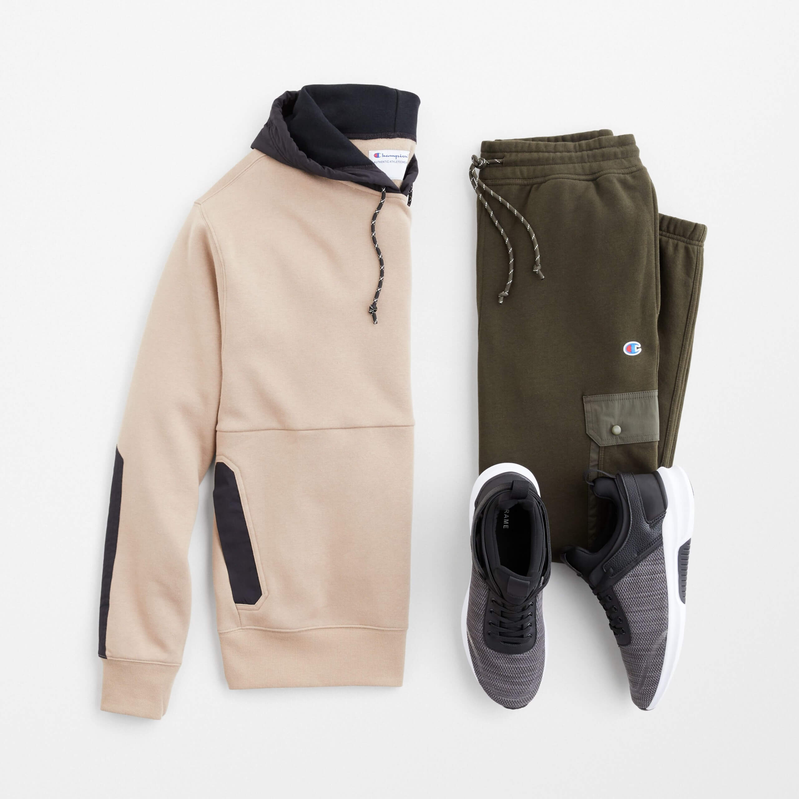 Stitch Fix men's outfit laydown featuring cream hoodie, olive joggers and black active sneakers. 