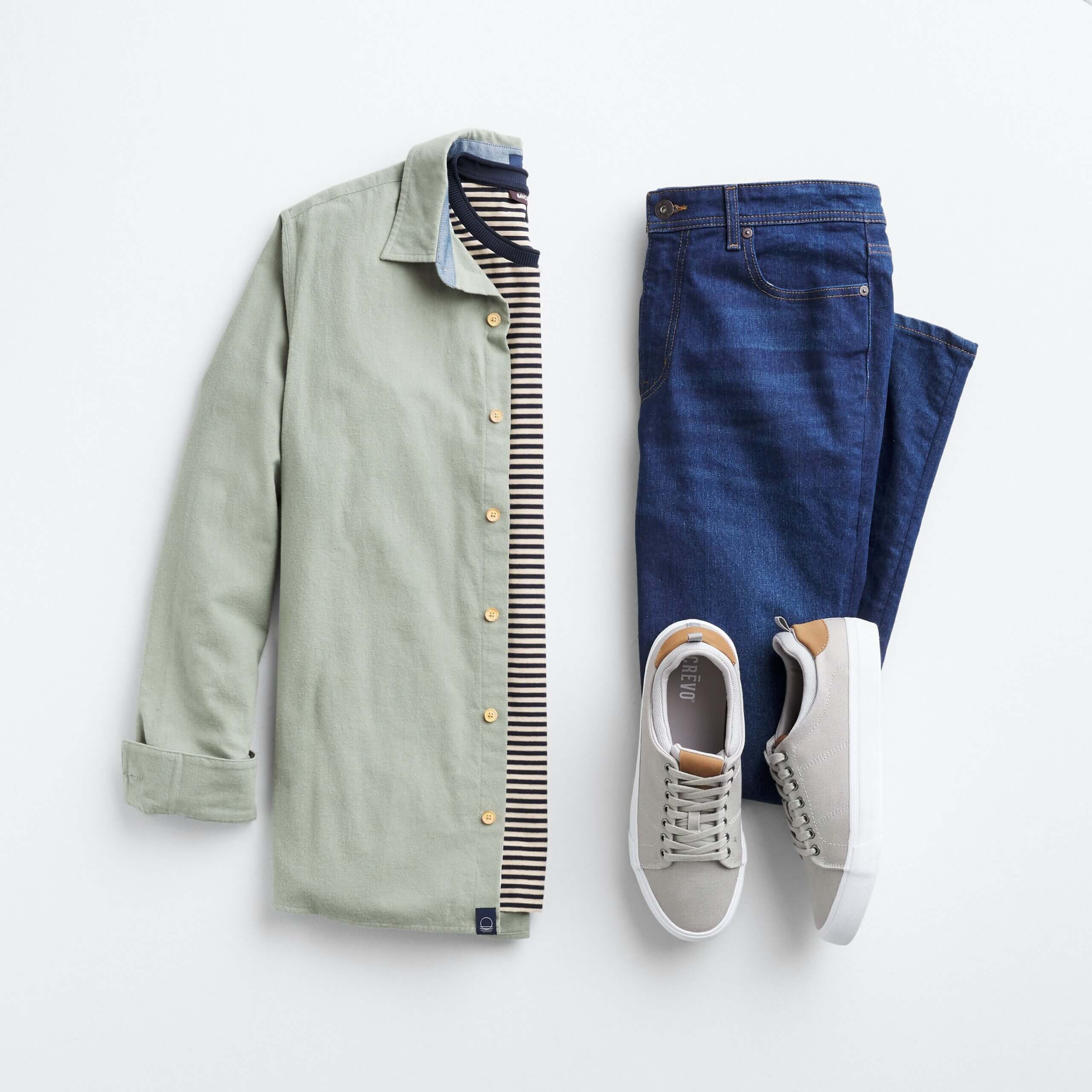 Stitch Fix men's outfit laydown featuring green button-down over striped tee, next to blue jeans and taupe sneakers. 