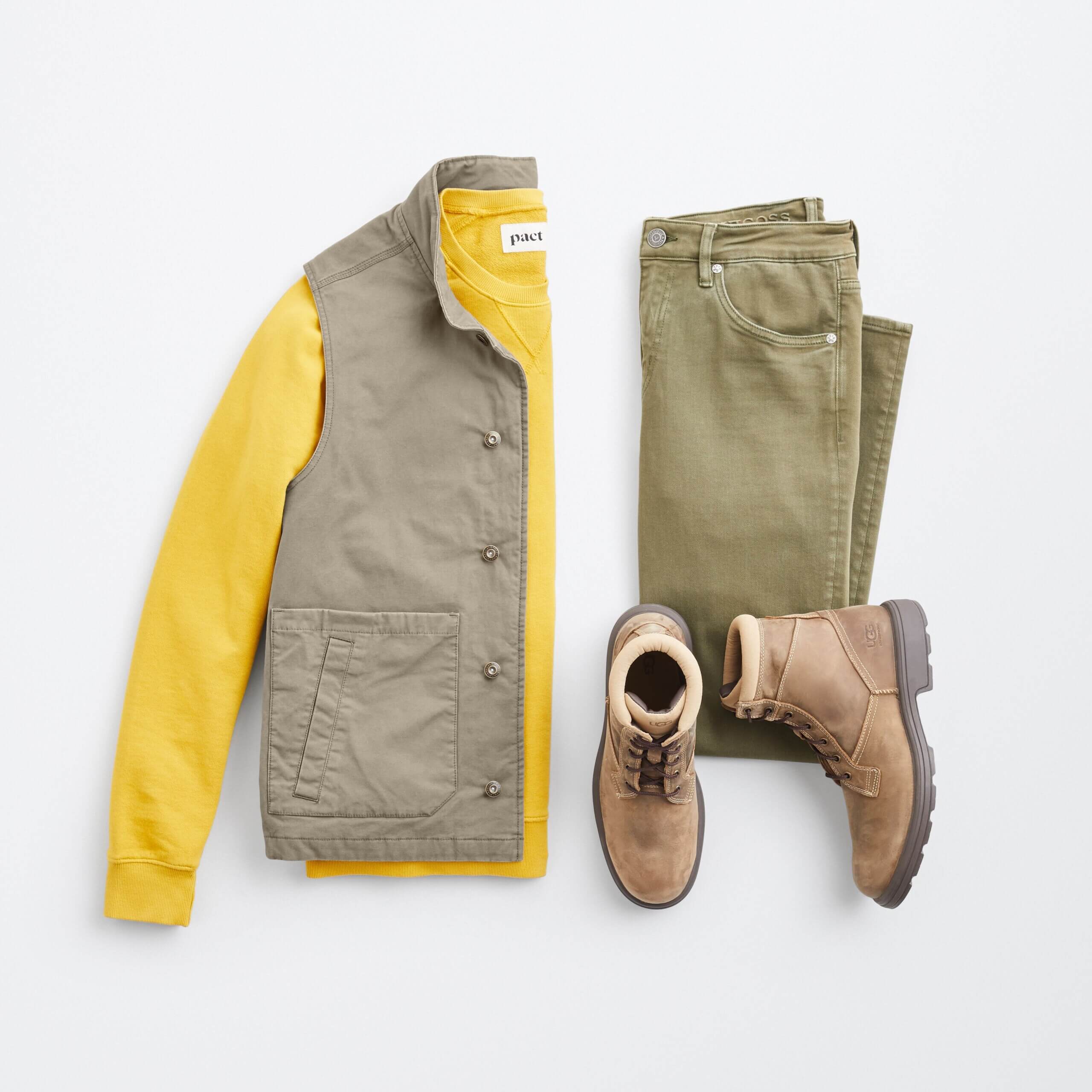 Stitch Fix Men's outfit laydown featuring cargo vest over yellow pullover, next to olive pants and brown boots. 