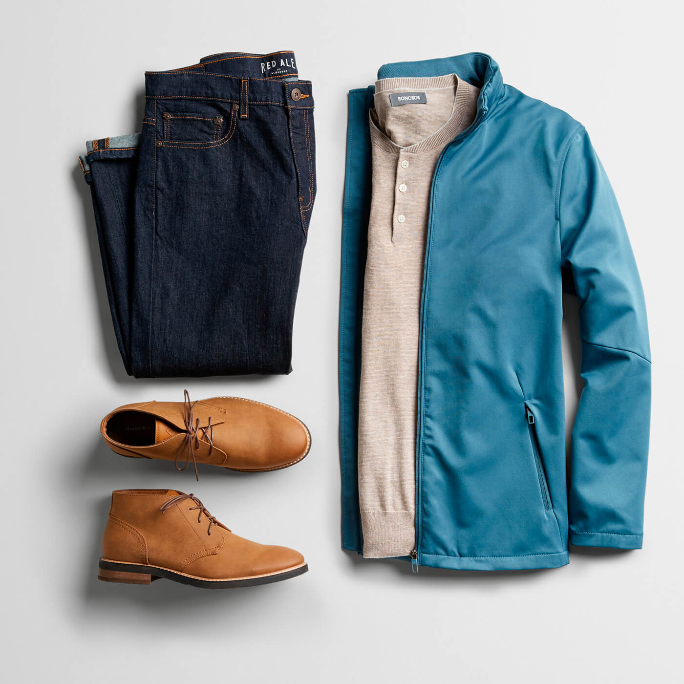 light blue jacket, tan henley, navy chinos and tan chukka boots