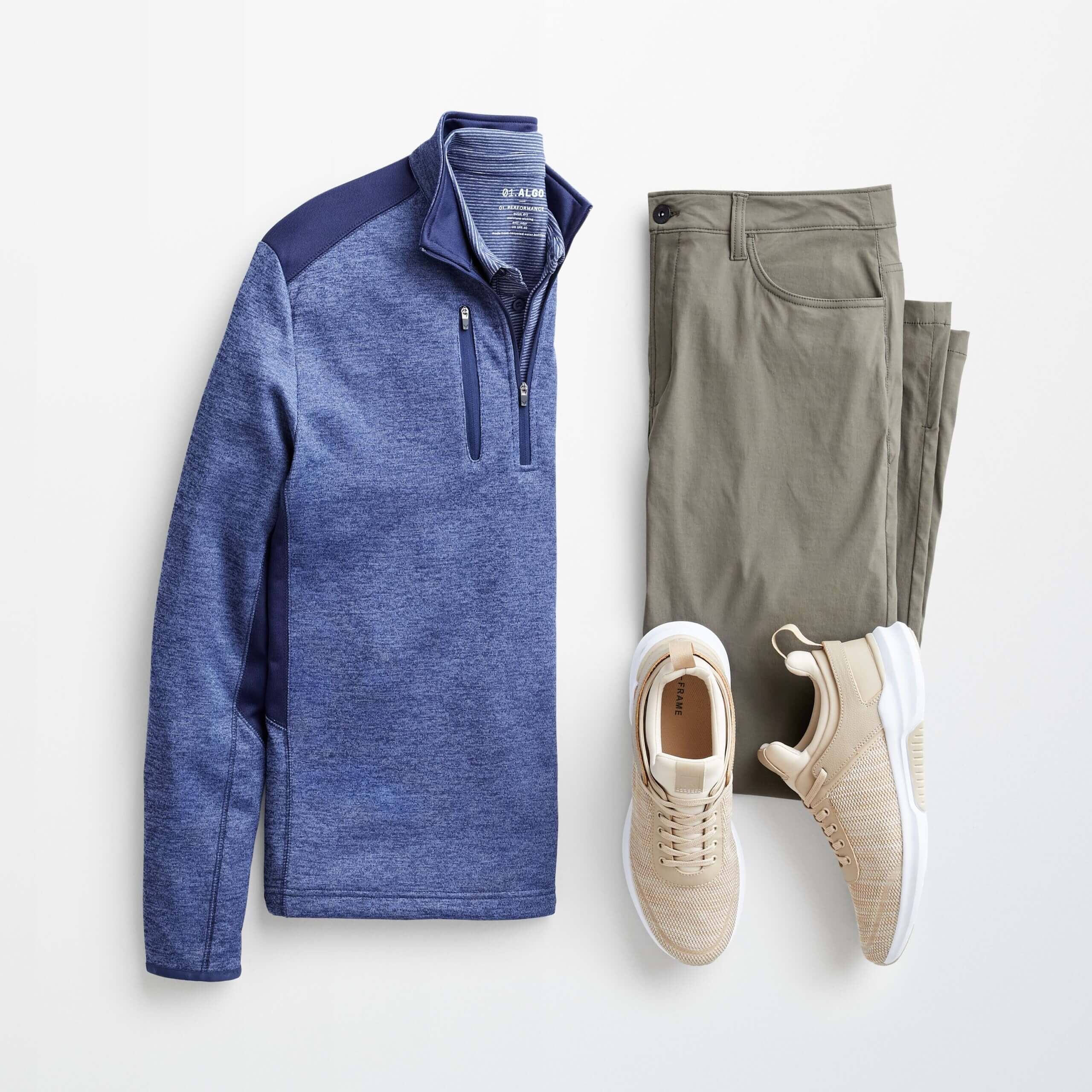 Stitch Fix Men’s outfit laydown featuring grey tech pants, blue 1/4 zip pullover and beige sneakers. 