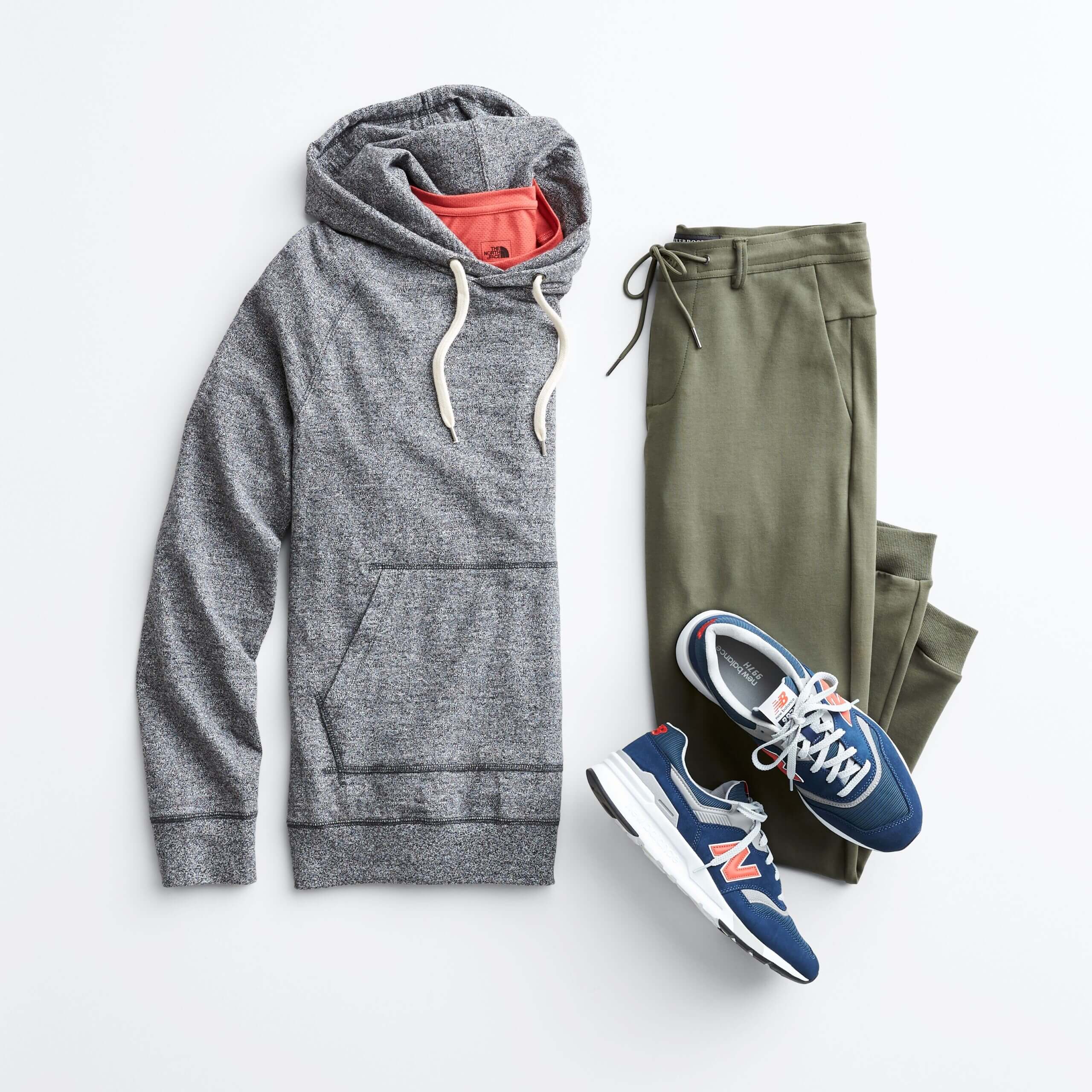Stitch Fix Men’s Jogger Set featuring a grey hooded sweatshirt, olive green joggers, red short-sleeve tee and blue sneakers.