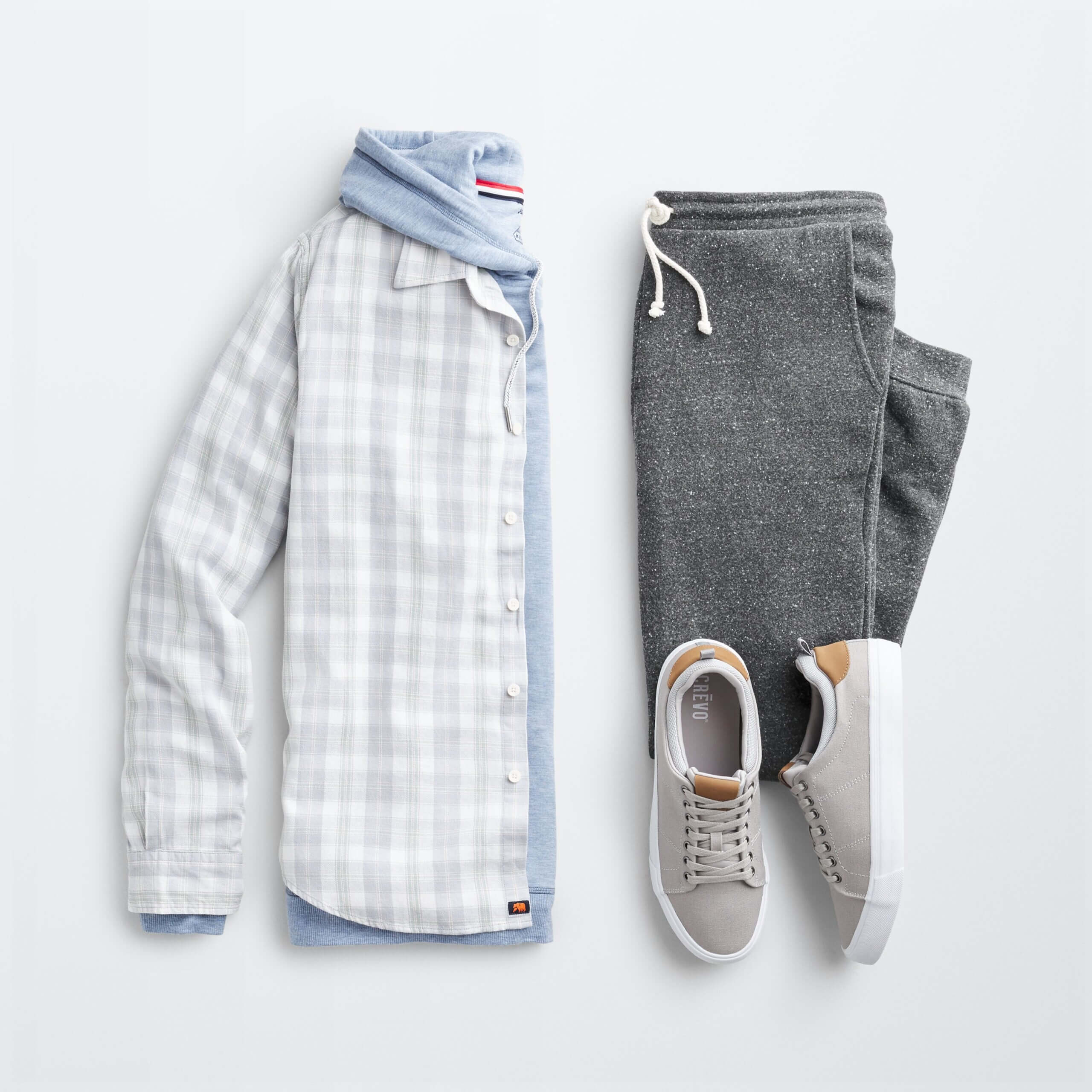 Stitch Fix Men’s shacket outfit with blue and white plaid shacket, blue hooded sweatshirt, gray jogger pants, gray sneakers.