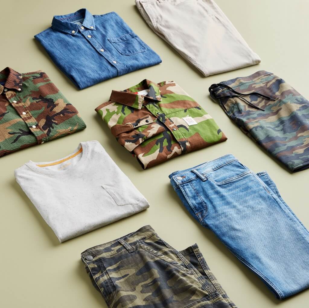 Stitch Fix men’s outfit laydown featuring camouflage items, chambray button-down shirt, white T-shirt and blue jeans.