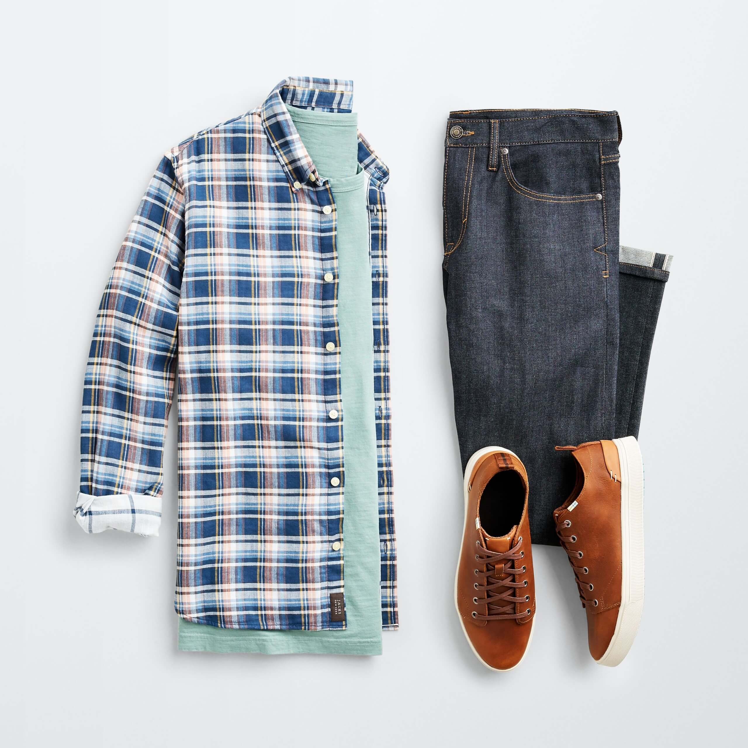 Stitch Fix Men’s outfit laydown featuring plaid shacket over mint green t-shirt, dark blue jeans and brown sneakers.