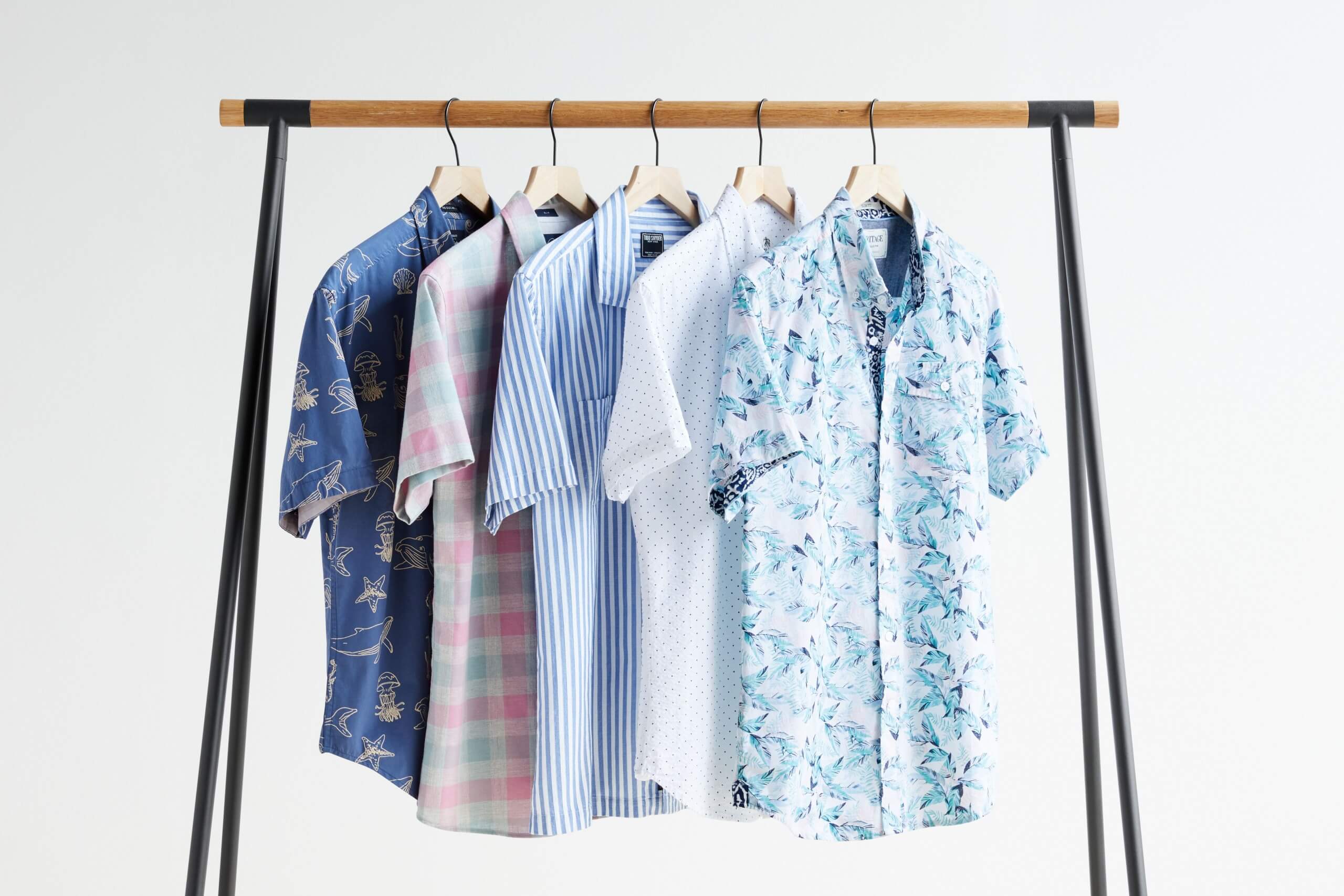 Stitch Fix men’s short-sleeve button-downs in various colors and prints hanging from a rack.