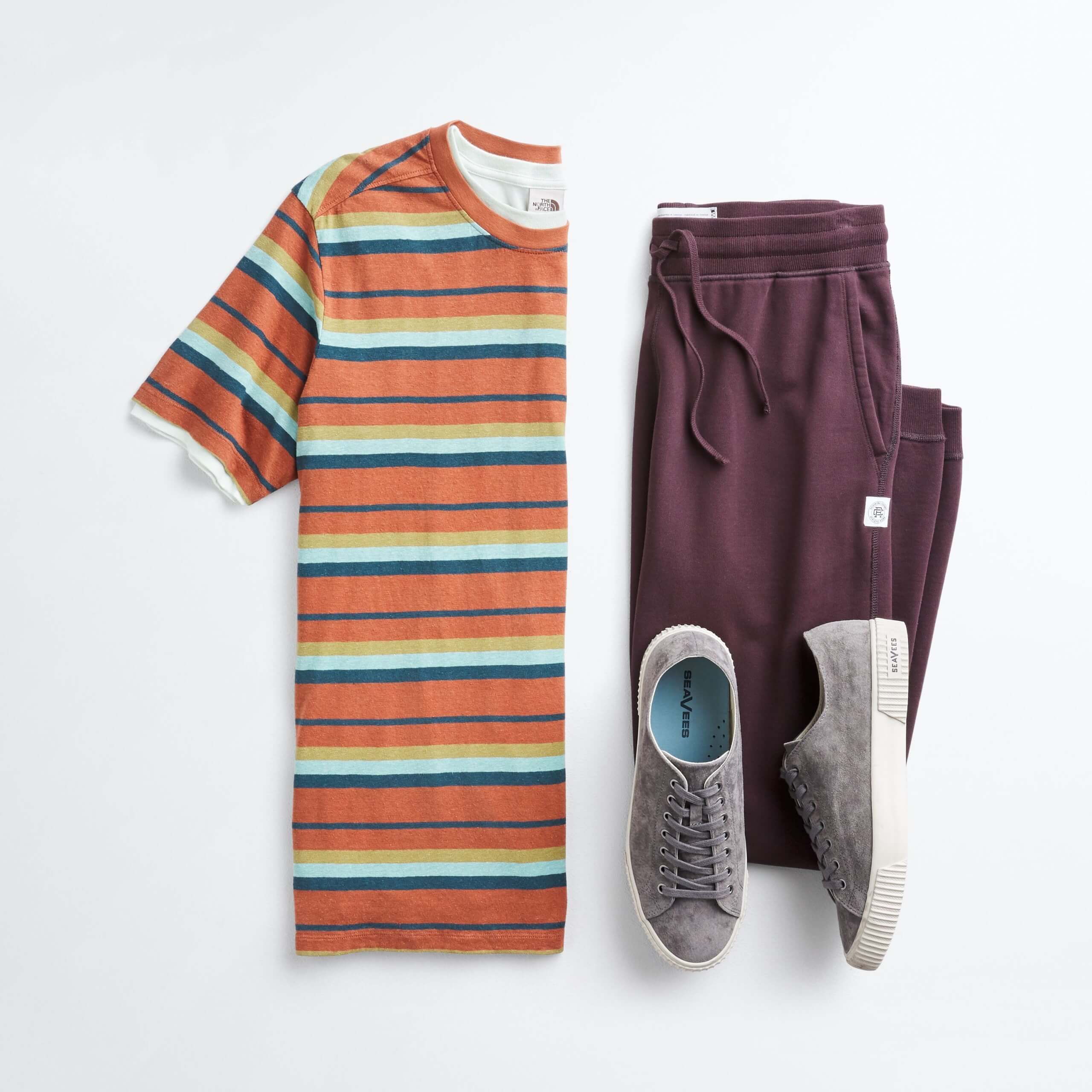 Stitch Fix men’s outfit laydown featuring multi-colored striped T-shirt, burgundy joggers and grey sneakers.