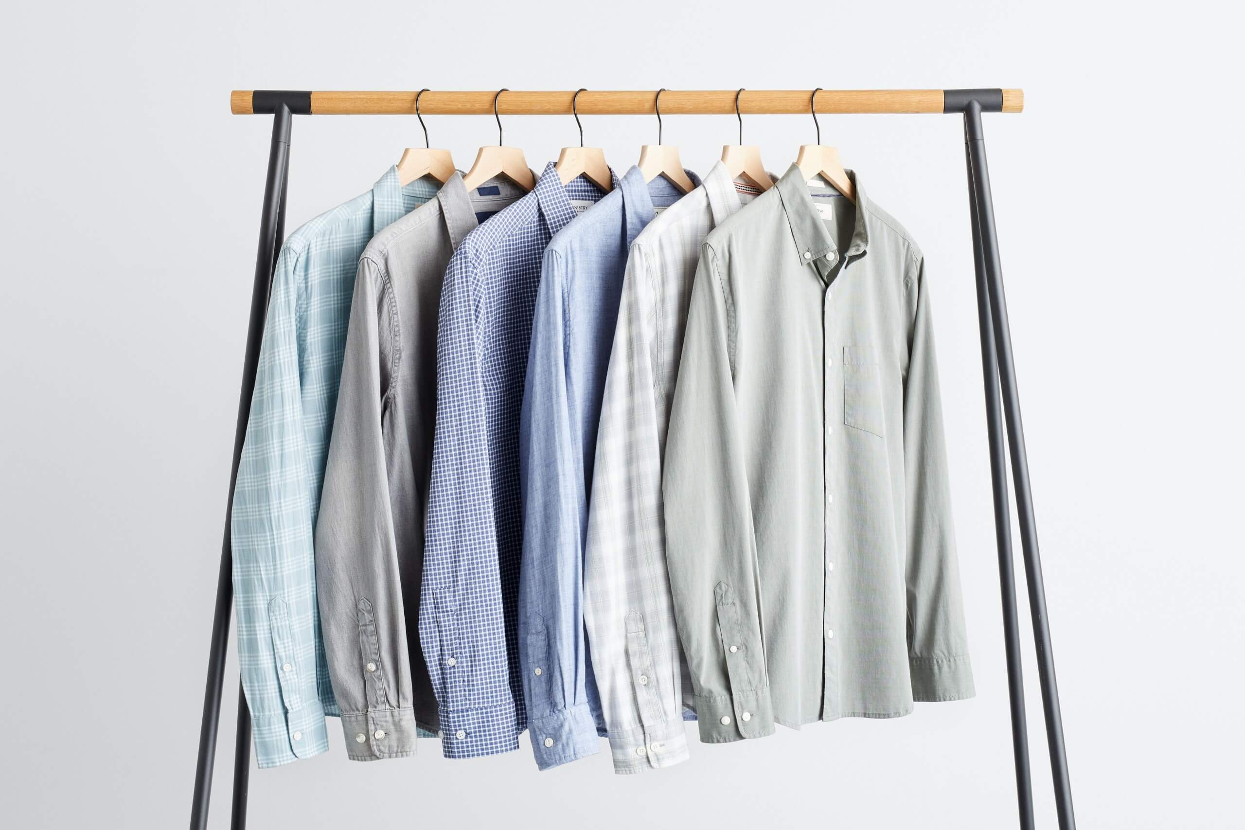 Stitch Fix men’s long-sleeve button-downs in various colors and prints hanging from a rack.