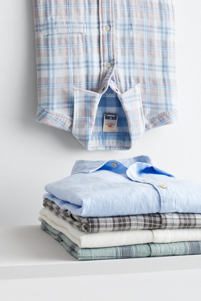 Stitch Fix men’s button-up shirts stacked in blue, white, grey and blue plaid with one vertically inverted.