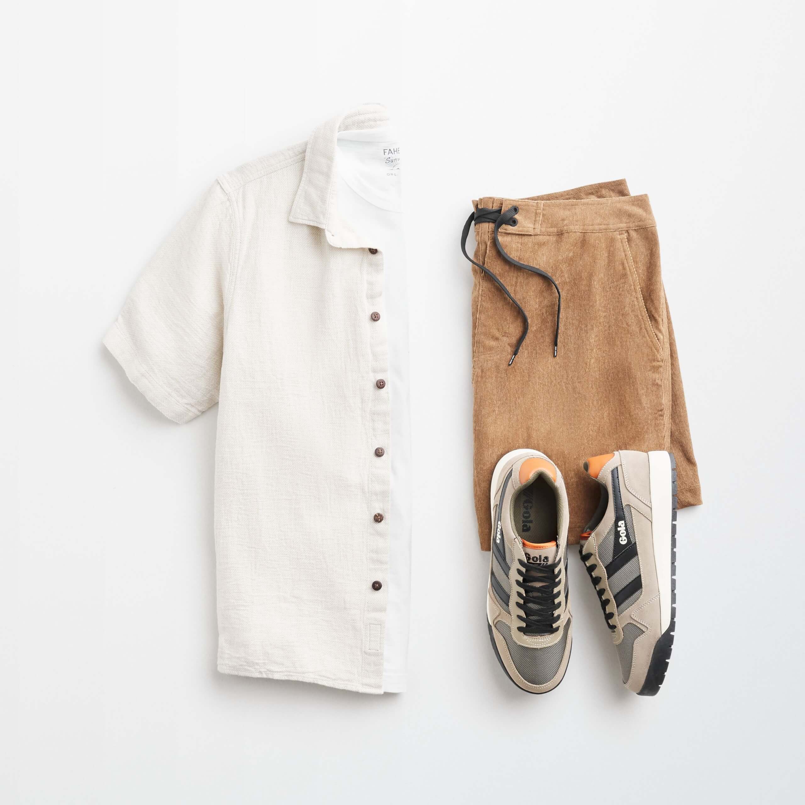 Stitch Fix men’s outfit laydown featuring short-sleeve button-down over white shirt, brown shorts and multi-colored sneakers.