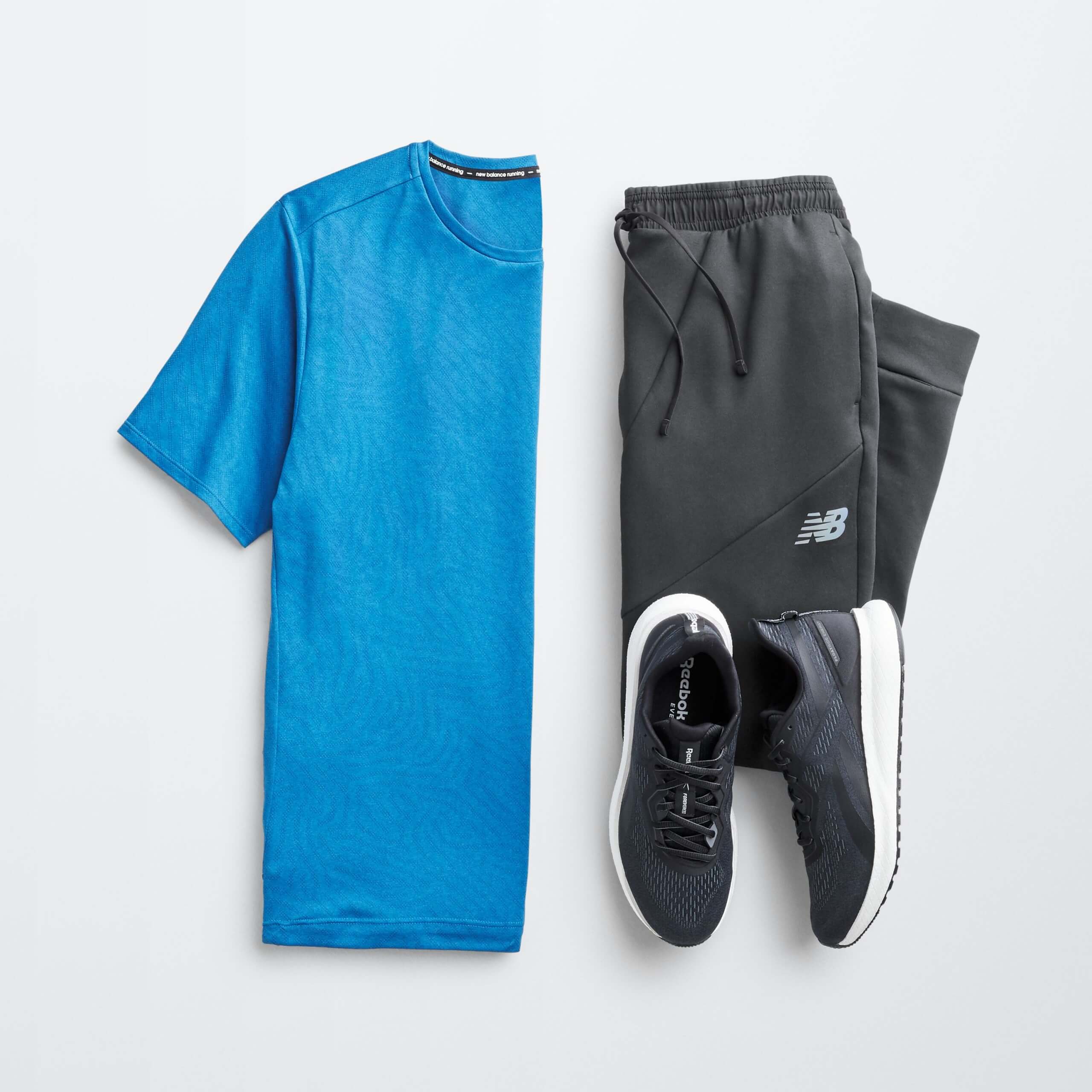Stitch Fix men’s outfit laydown featuring blue T-shirt, black joggers and black sneakers.