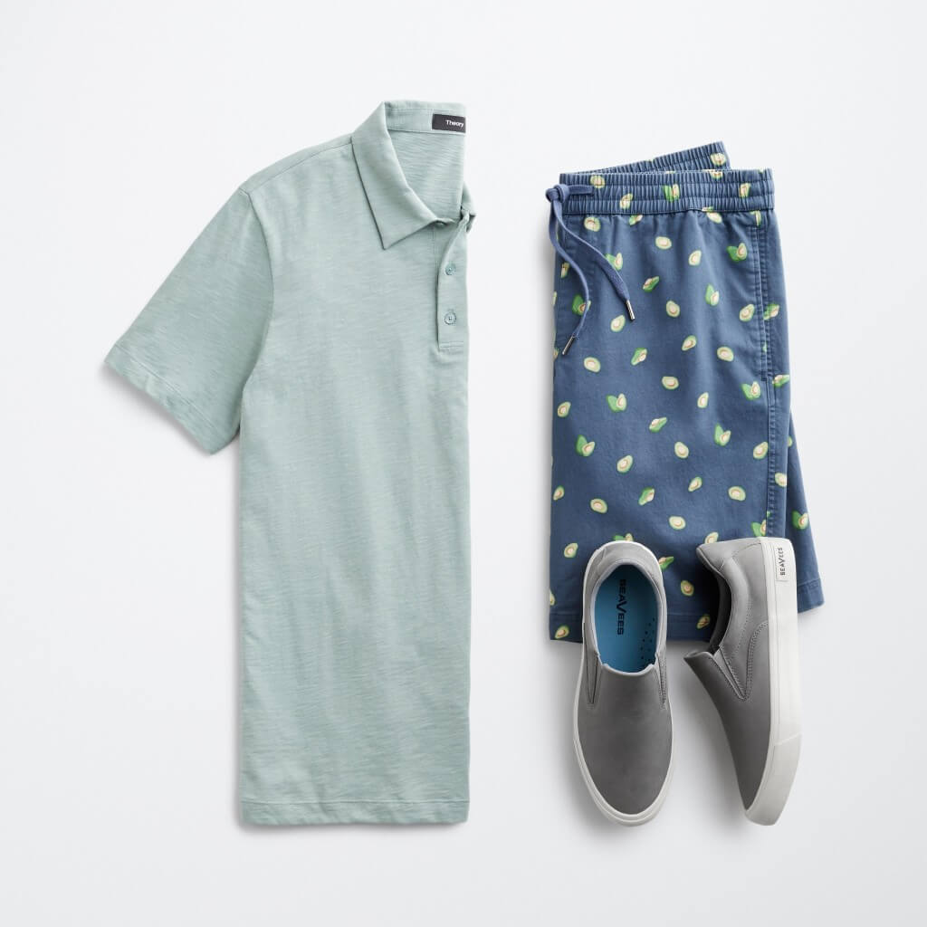 Stitch Fix men’s outfit laydown featuring mint polo, lemon-patterned drawstring shorts and grey sneakers.