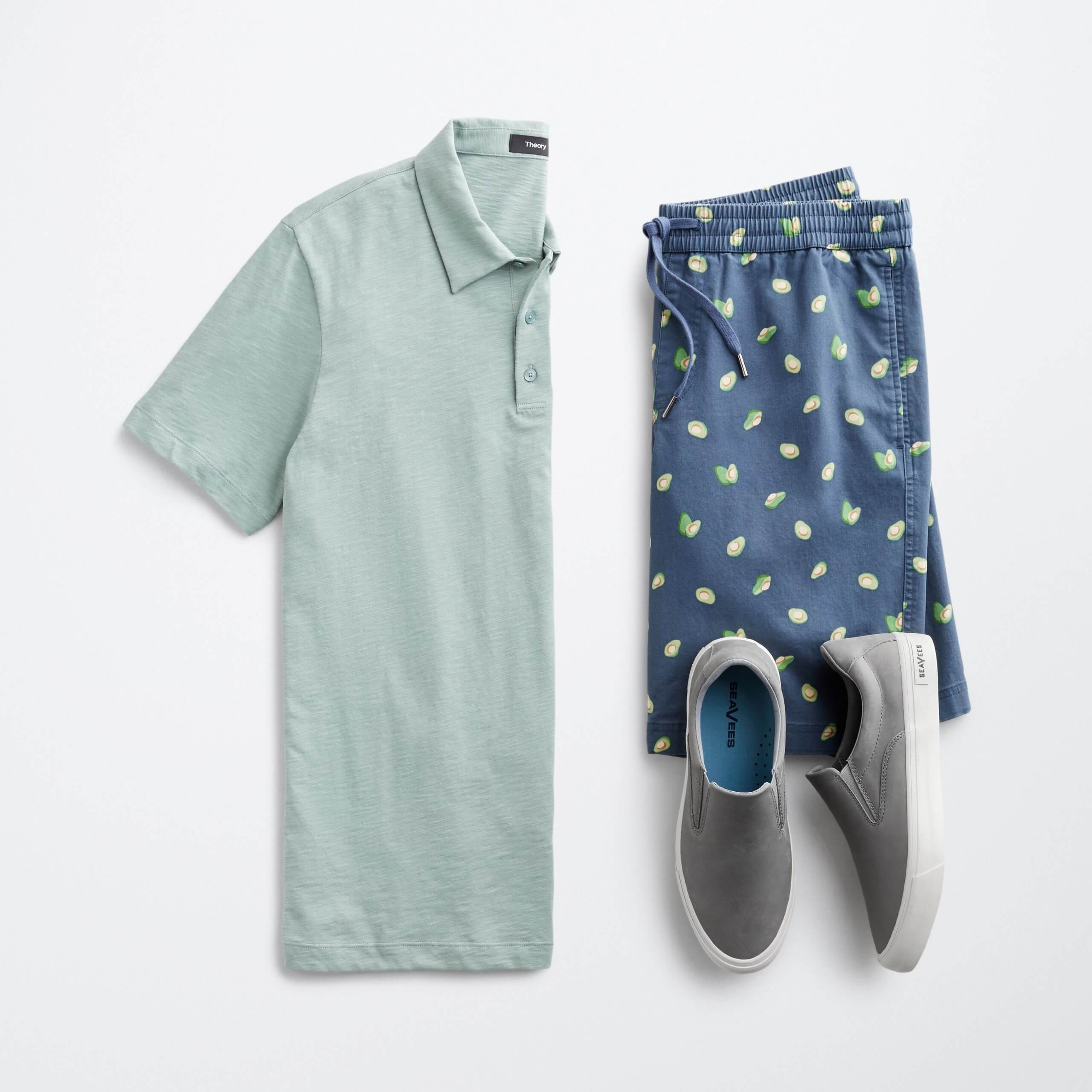 Stitch Fix men’s outfit laydown featuring mint polo, lemon-patterned drawstring shorts and grey sneakers.
