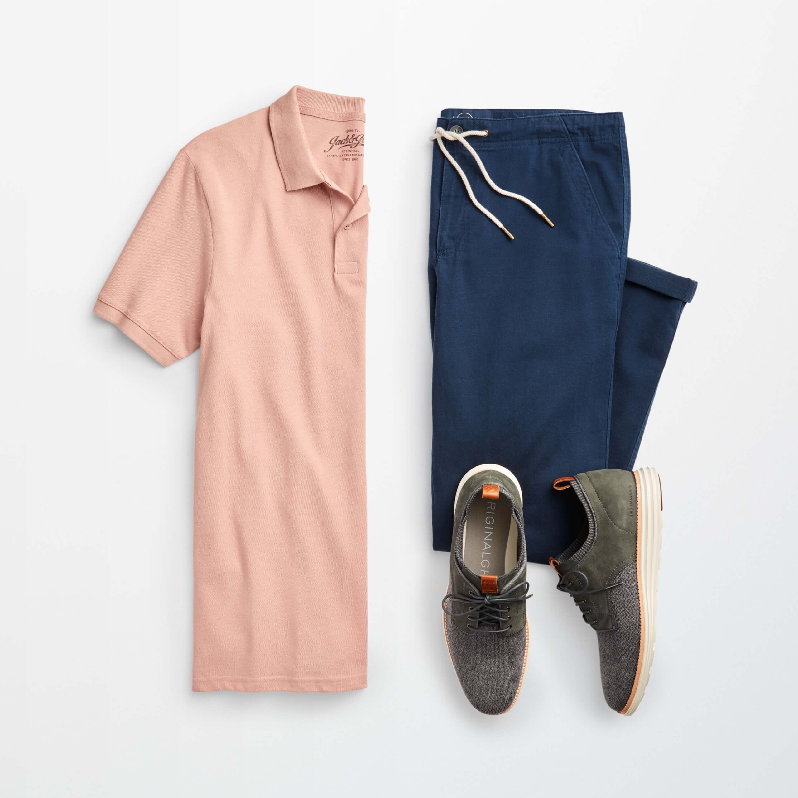 Stitch Fix men’s back to the office outfit with navy joggers, pink polo shirt and grey lace-up shoes with sport-bottom.