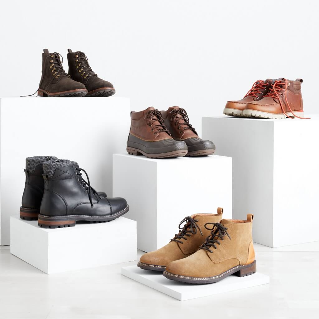 Stitch Fix men’s boots arranged on white blocks in a variety of colors and styles.