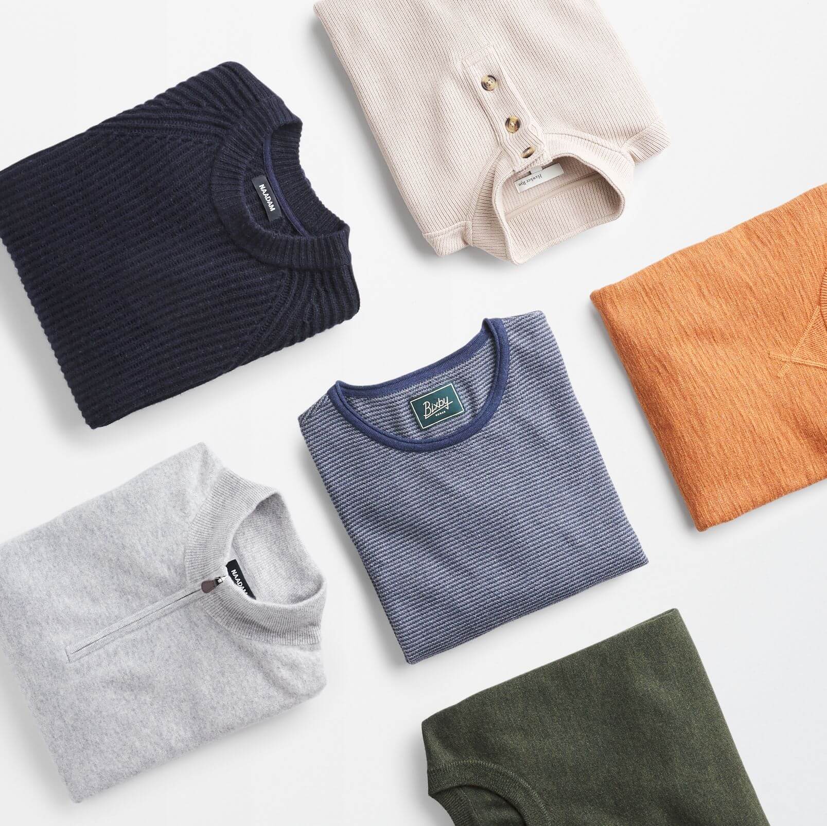 Stitch Fix men’s sweaters and shirts with navy T-shirt, orange sweatshirt and sweaters in grey, olive, navy and beige.