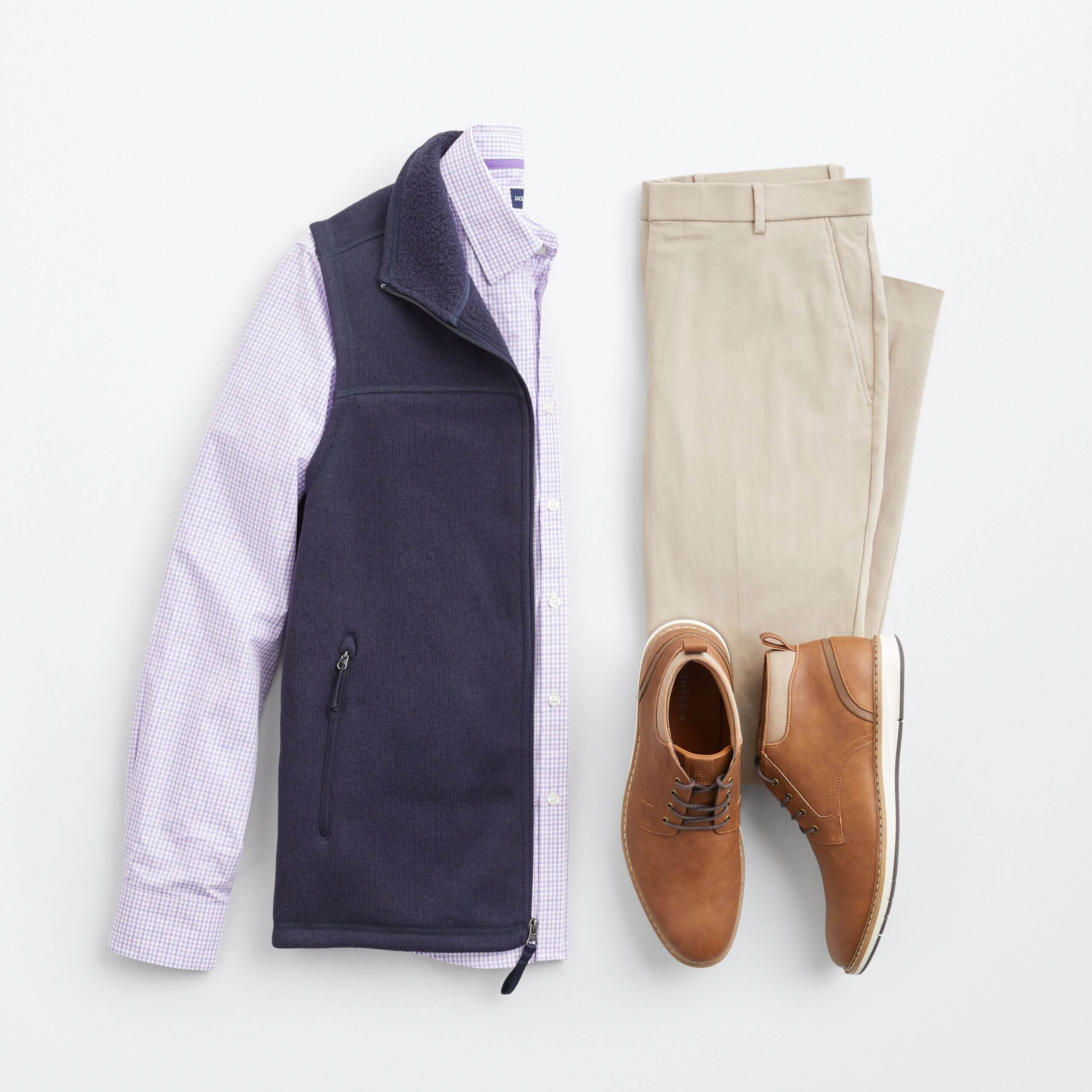 Stitch Fix men’s back to the office outfit featuring light-wash blue jeans, navy crew neck T-shirt with white stripes and grey flannel sneakers.
