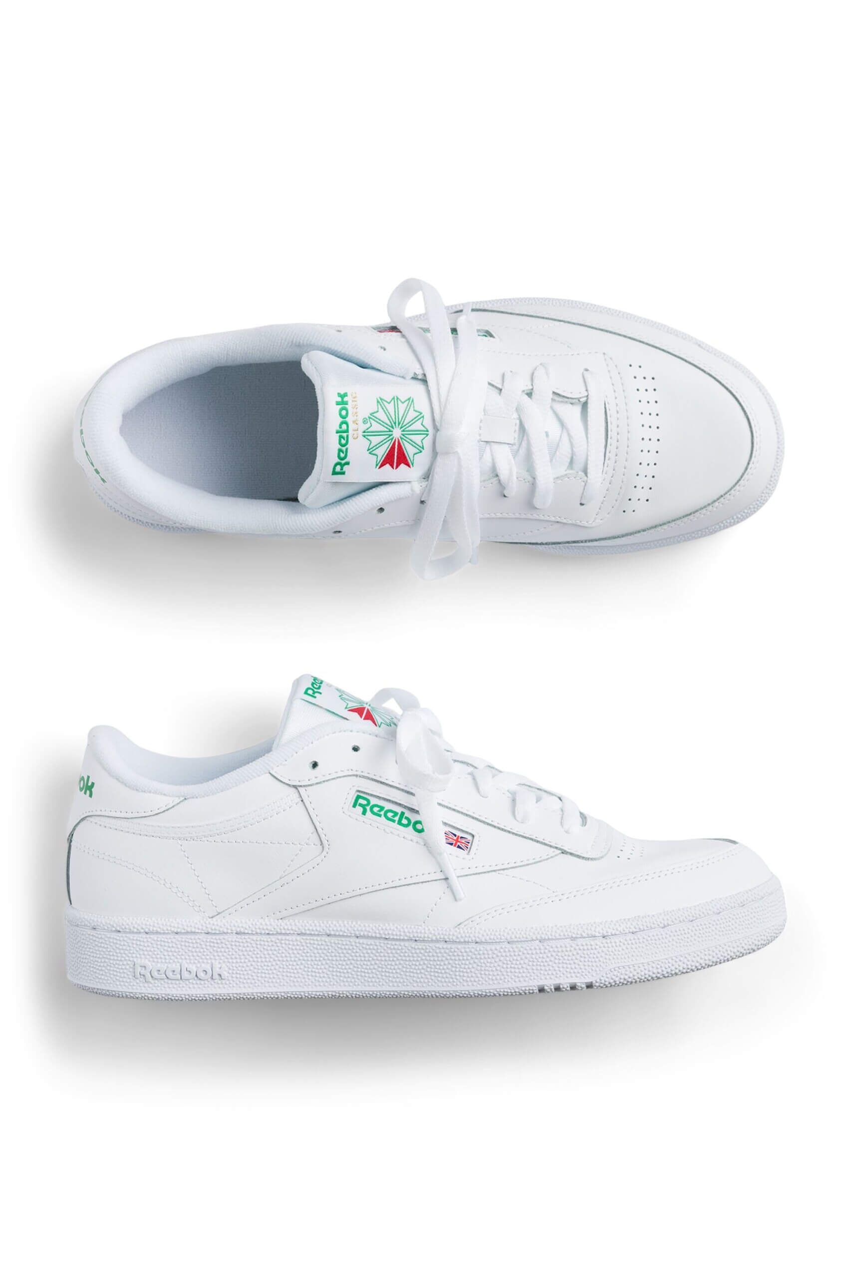 Stitch Fix men’s white sneakers with “Reebok” in green on the tongue and side.