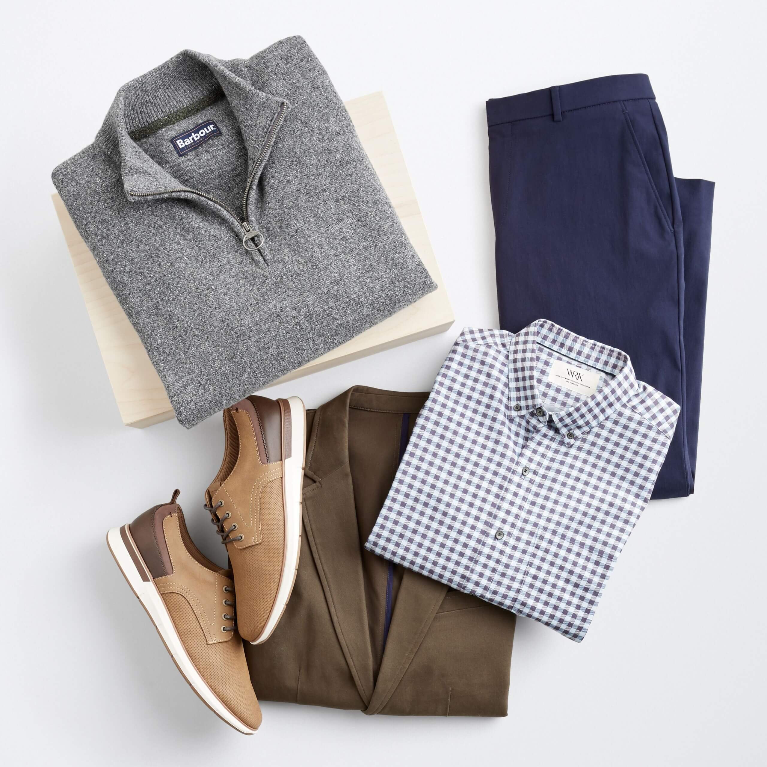 Stitch Fix men’s winter outfit with grey quarter zip, navy trousers, blue and white button-down shirt, brown blazer and light brown shoes.