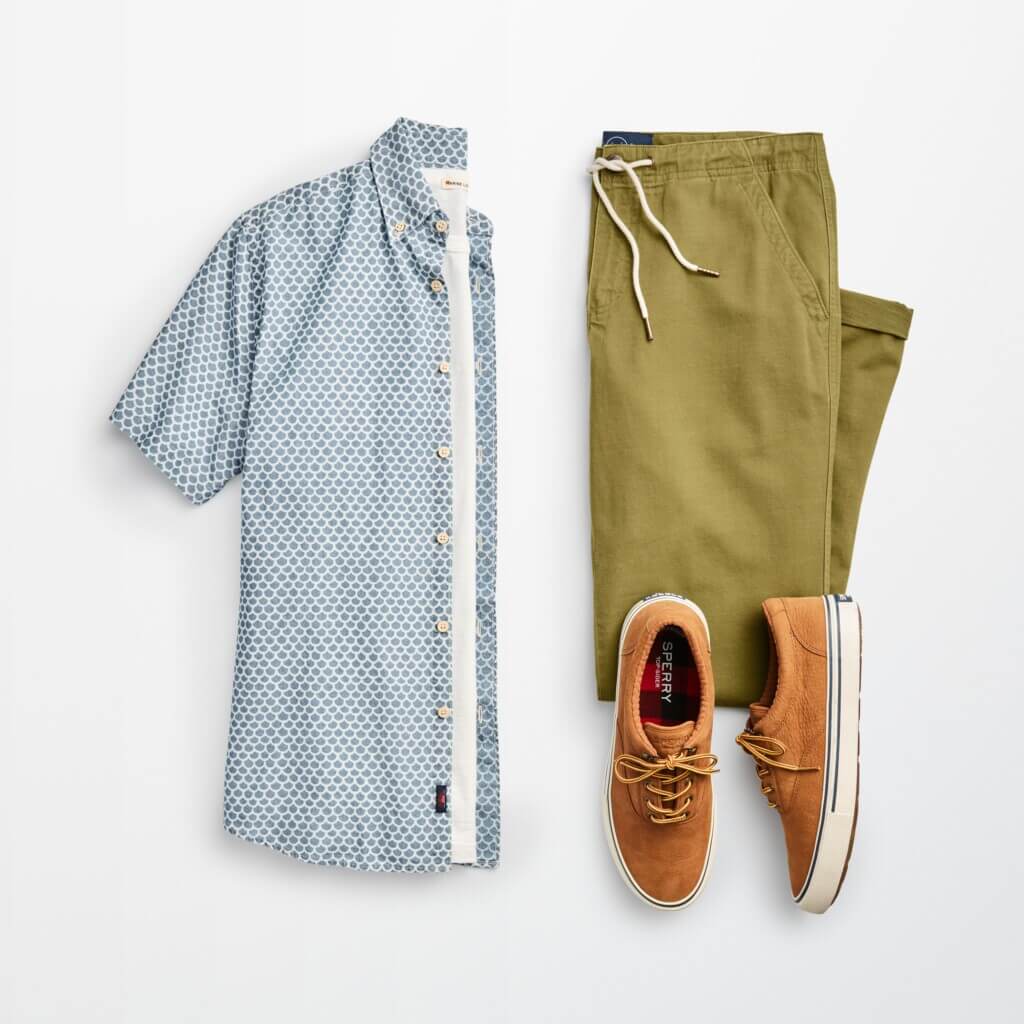 Stitch Fix men’s casual office outfit with blue short-sleeve button-down shirt over white T-shirt, olive pants and brown sneakers.