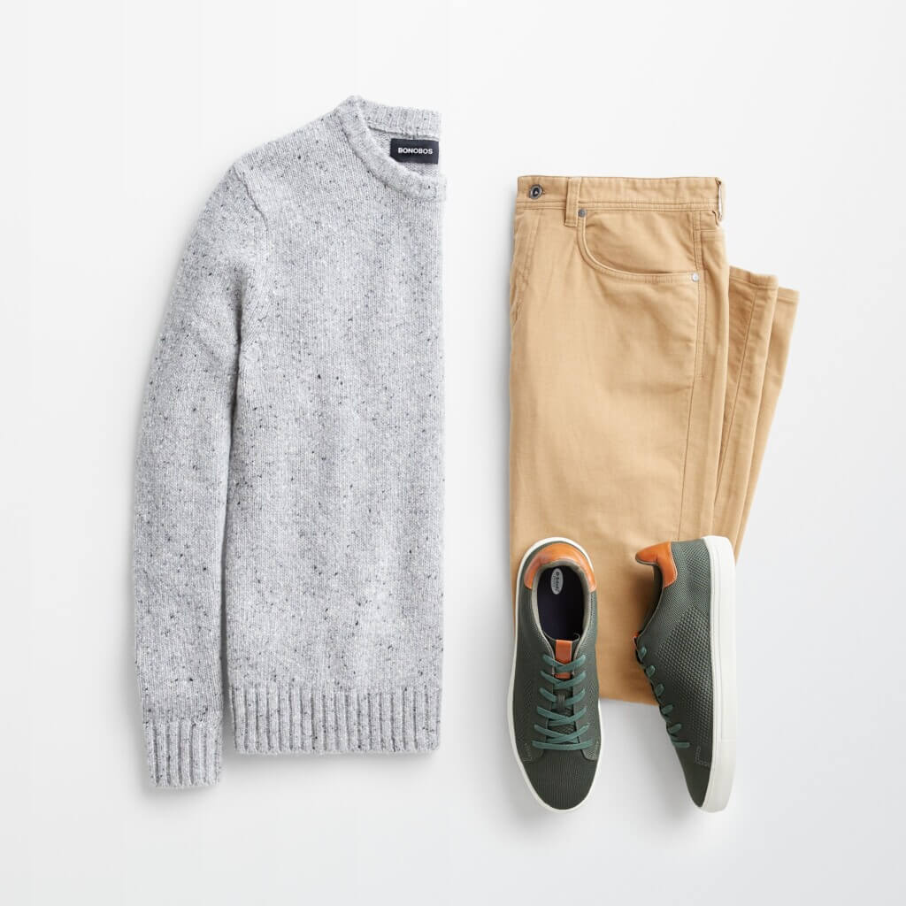 Stitch Fix men’s casual office outfit with grey sweater, khaki pants and green sneakers with burnt orange accents.