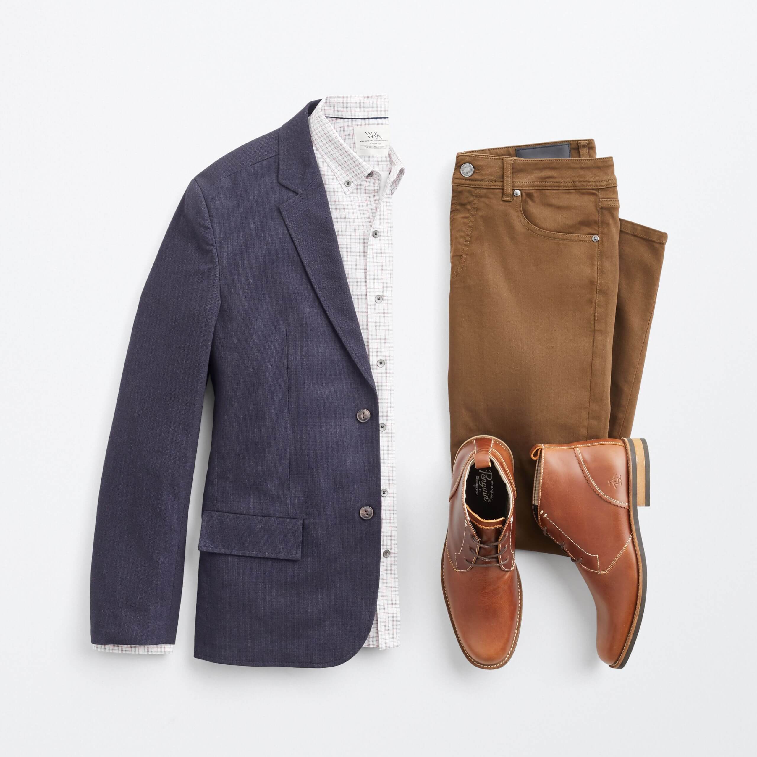 Stitch Fix men’s outfit with navy blazer over white plaid button-down shirt, brown jeans and cognac boots.