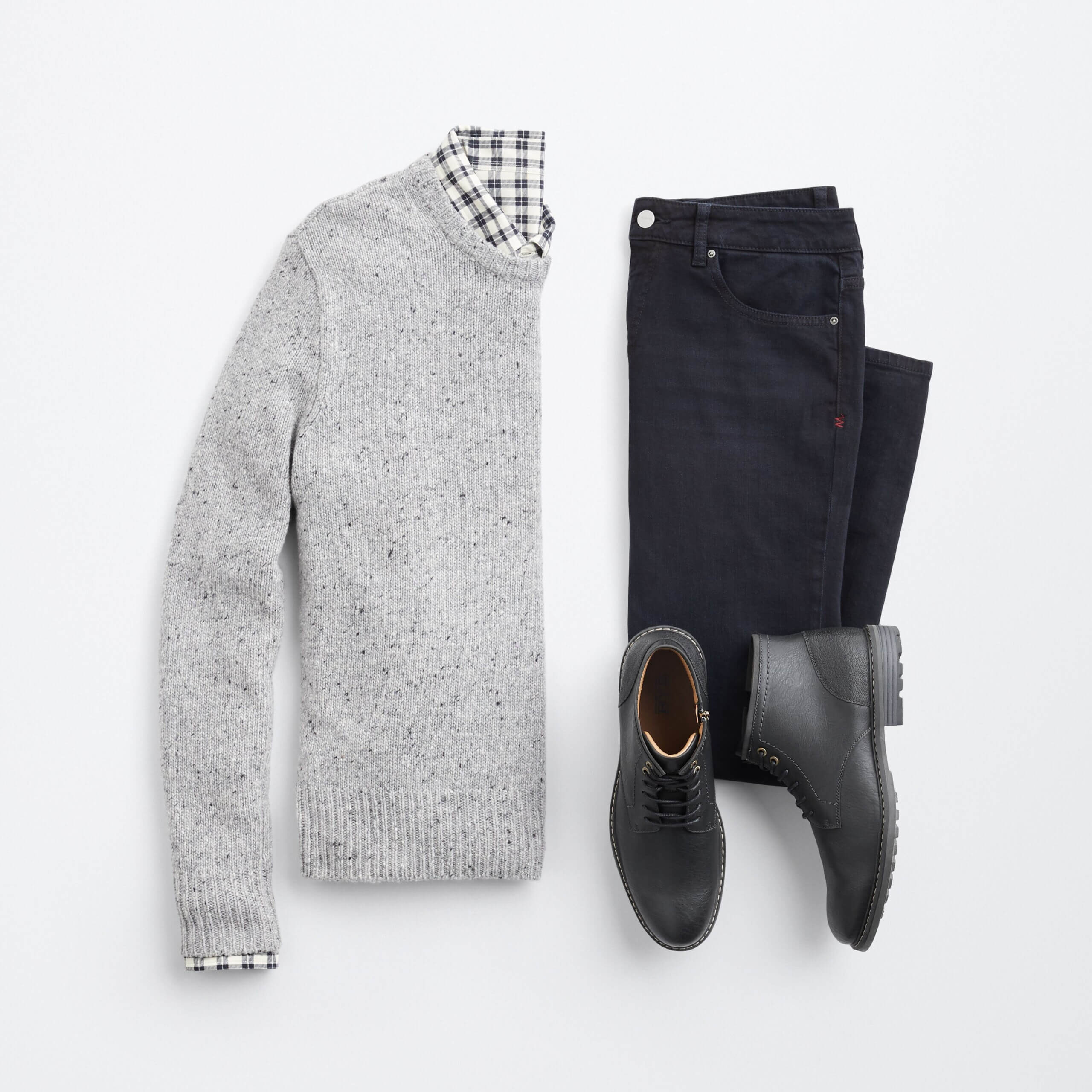 Stitch Fix Men's suit with gray pullover sweater, black and white plaid shirt, black jeans and black boots.