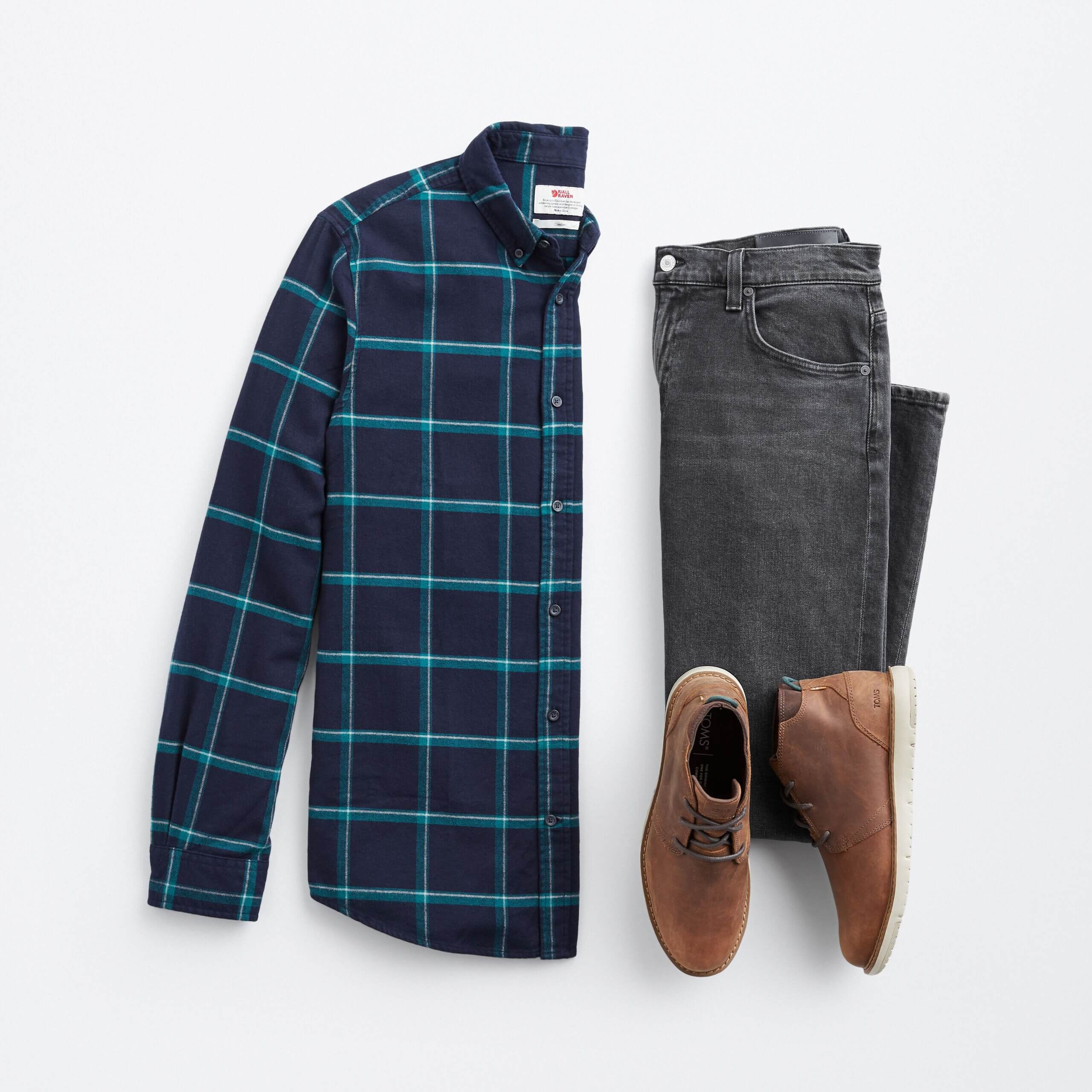 Stitch Fix men's New Year's Eve outfit featuring navy and green plaid button-down shirt, grey jeans and brown boots.