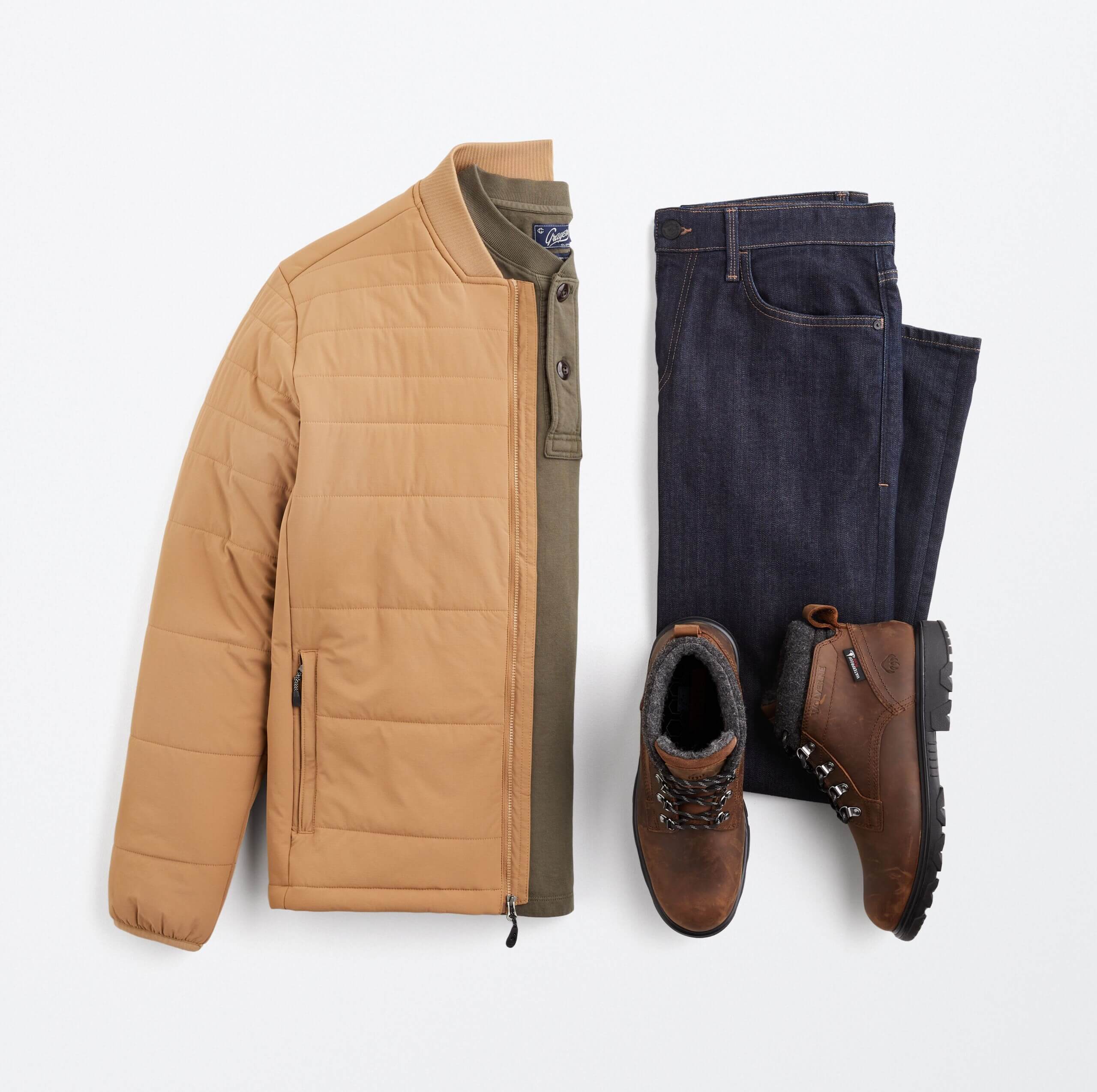 Stitch Fix men’s big and tall outfit with olive henley, tan puffer jacket, blue jeans and brown hiking boots.