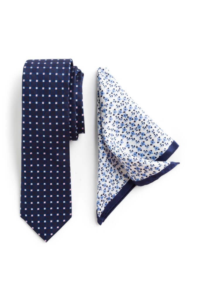 Stitch Fix men’s navy and white printed necktie next to white, blue and navy microfloral pocket square.