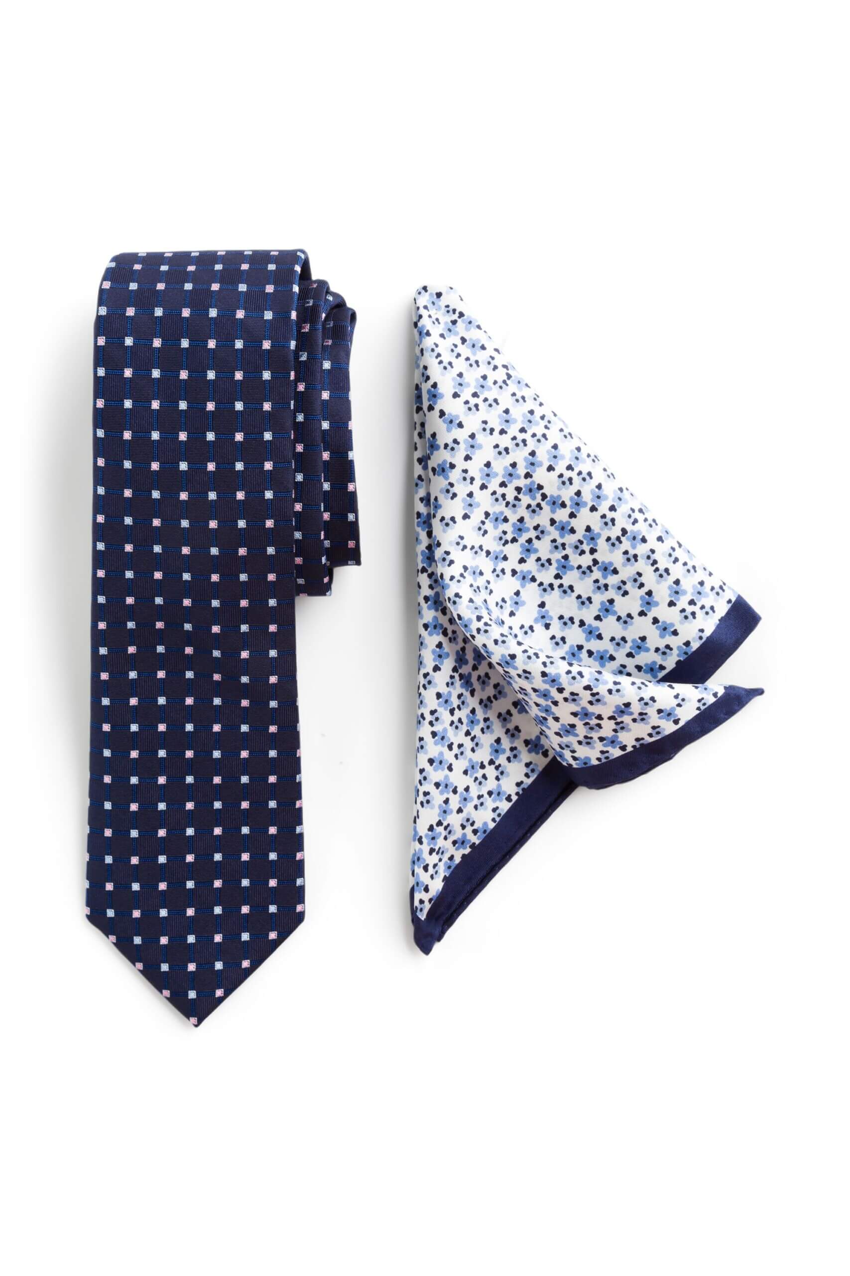 Stitch Fix men’s navy and white printed necktie next to white, blue and navy microfloral pocket square.