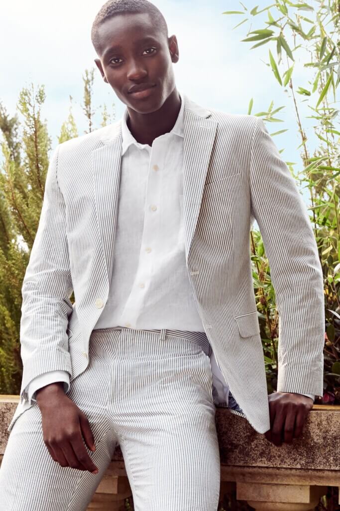 Stitch Fix men's spring wedding guest attire on model featuring grey and white striped suit over white button-down shirt.