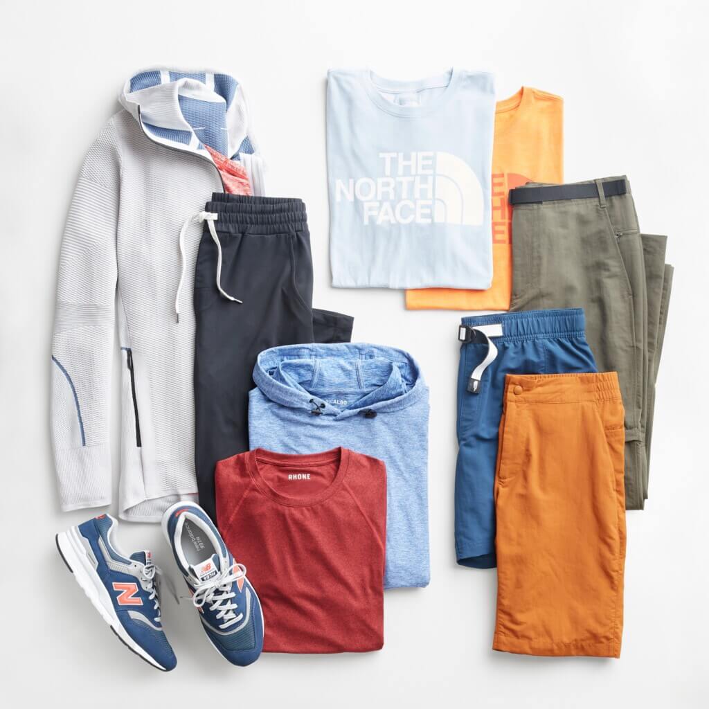 Stitch Fix men’s gorpcore attire with joggers, shirts and hoodies in various colors with blue, pink and white sneakers.