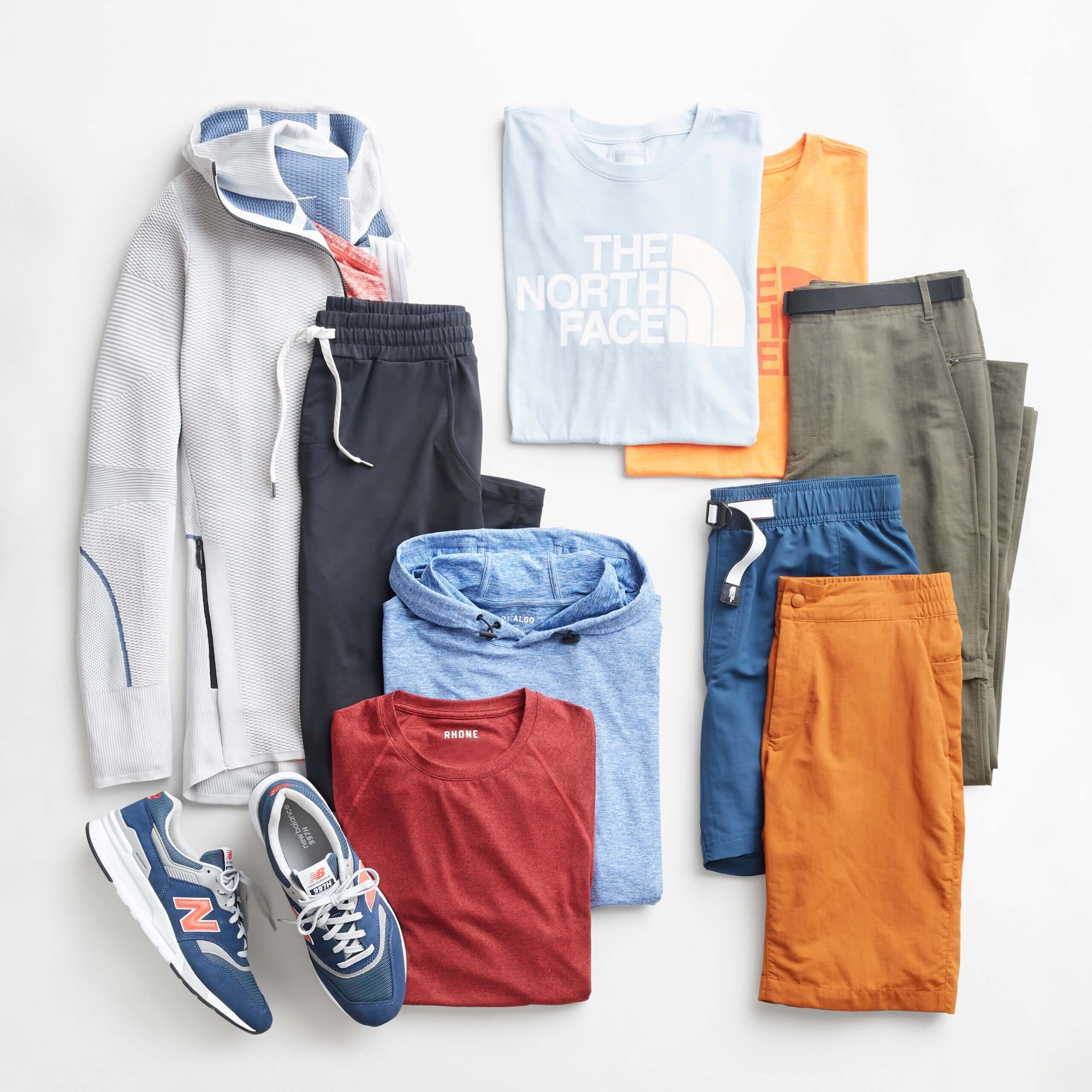 Stitch Fix men’s gorpcore attire with joggers, shirts and hoodies in various colors with blue, pink and white sneakers.