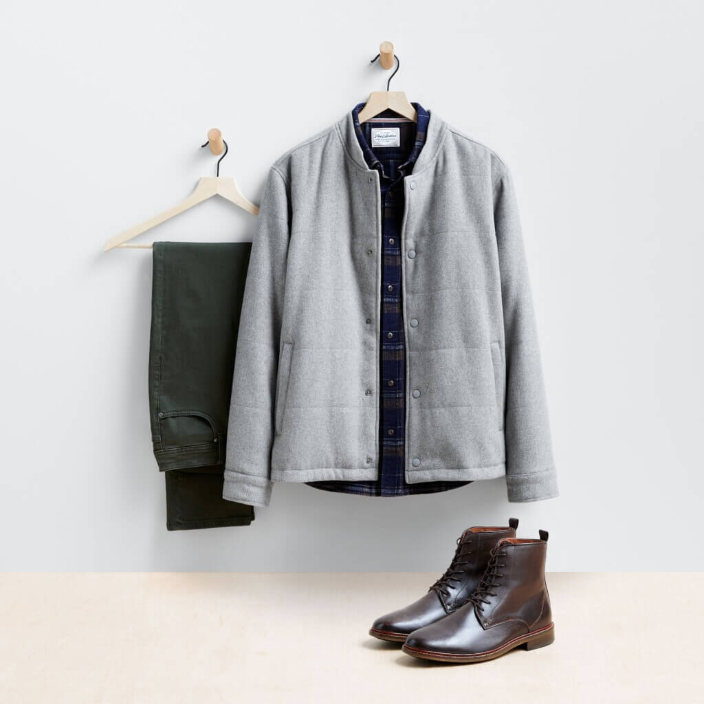 Stitch Fix Men’s Valentine's Day outfit featuring black pants on hanger next to black shirt with gray shacket on hanger and brown boots.