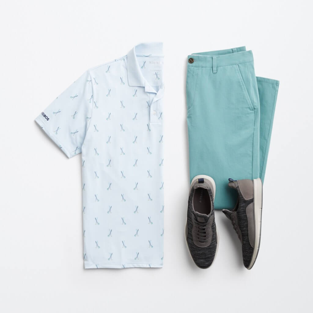 Stitch Fix men’s golf outfit featuring teal green pants, light blue critter print polo shirt and navy sneakers.