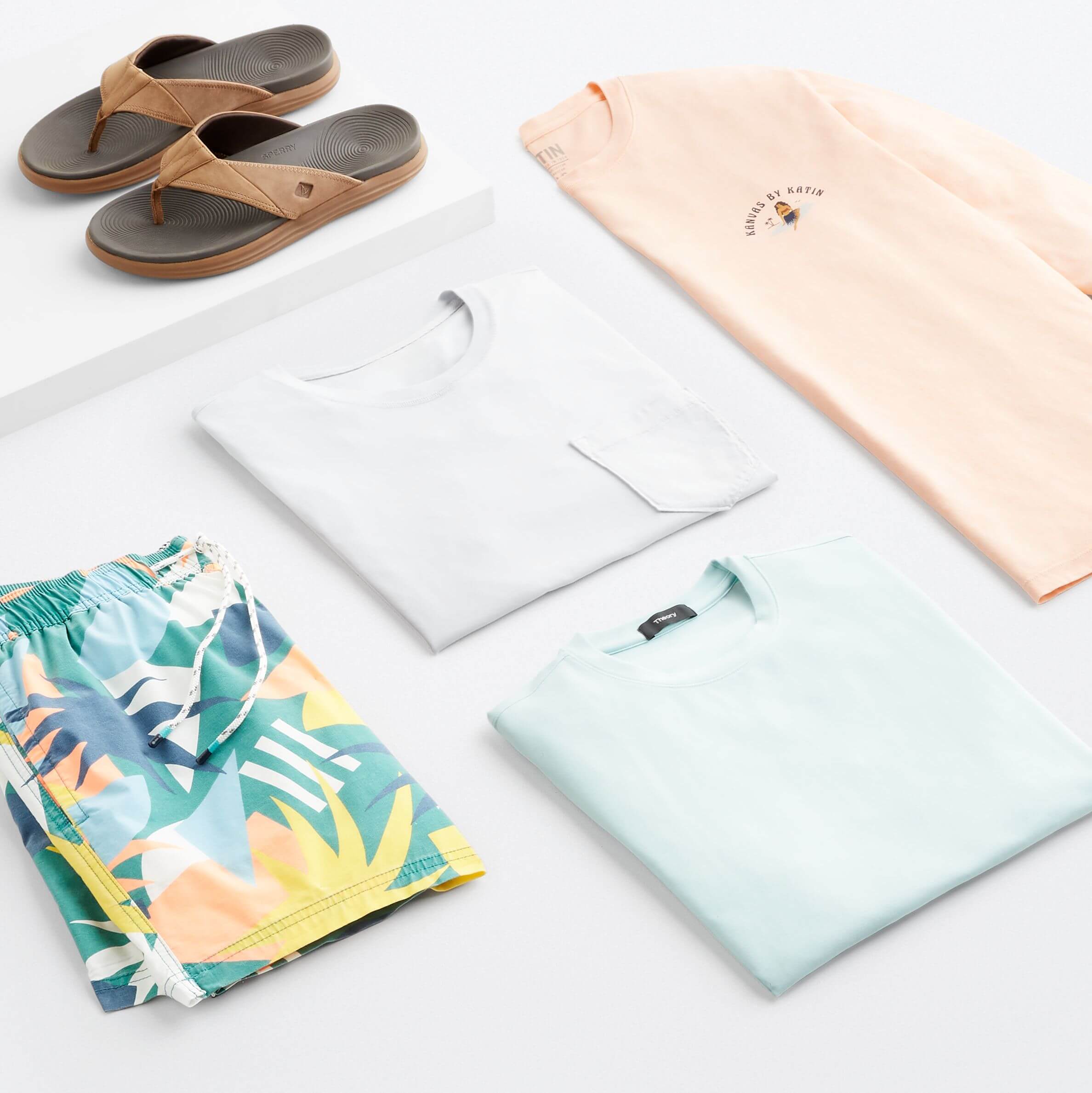 Stitch Fix men’s beach wear outfit featuring tropical print board shorts, T-shirts and sandals.