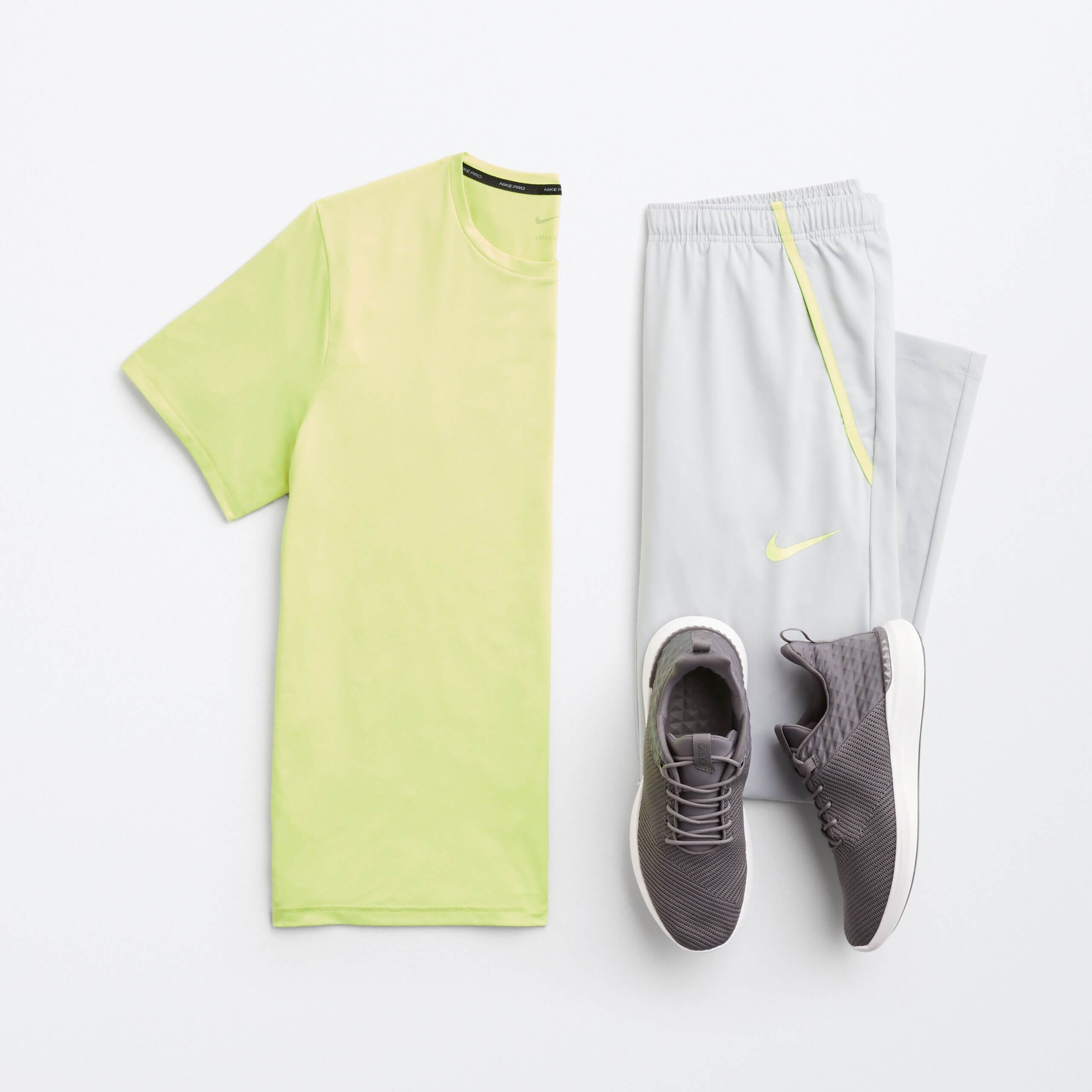 Stitch Fix men’s beach wear outfit featuring neon green T-shirt, light grey joggers and dark grey sneakers.
