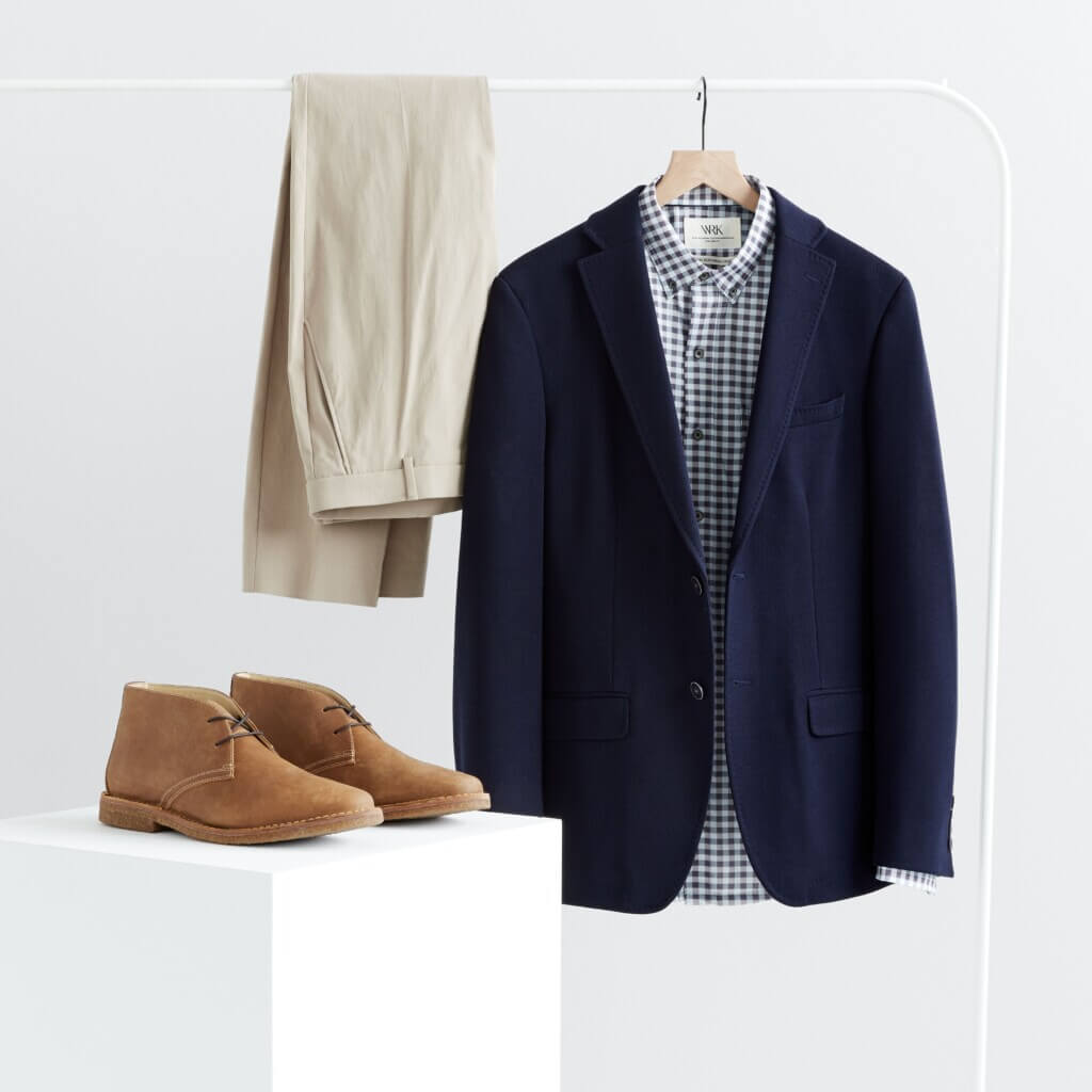 Stitch Fix men’s semi-formal wedding attire outfit with tan trousers, navy sport coat, button-down shirt and brown chukkas.