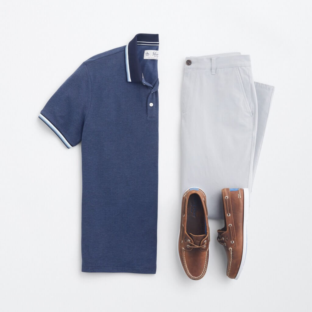 Stitch Fix men’s Y2K outfit for men featuring navy polo shirt, grey chino pants and brown boat shoes.