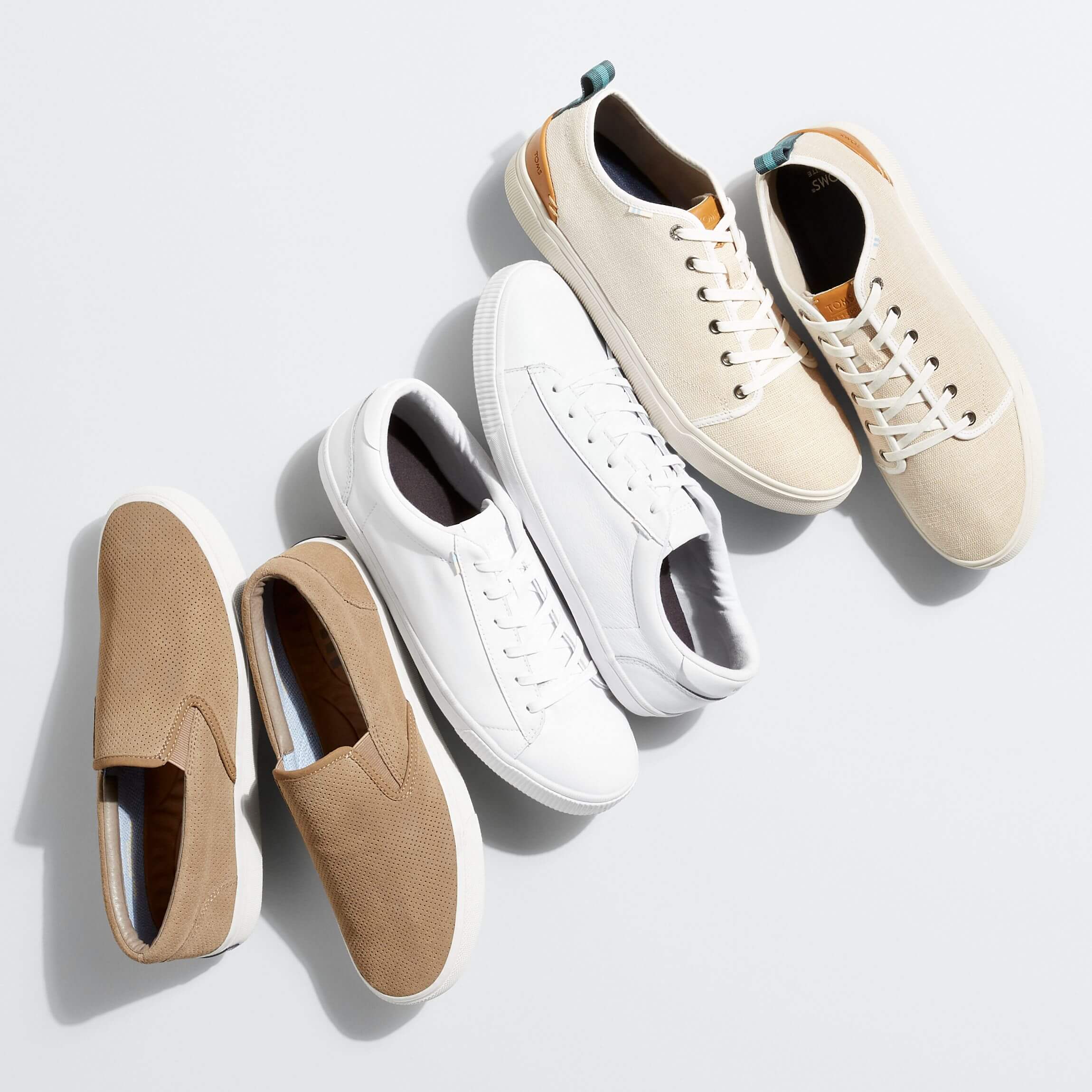 Stitch Fix men's business stack of casual sneakers in a variety of neutral shades.