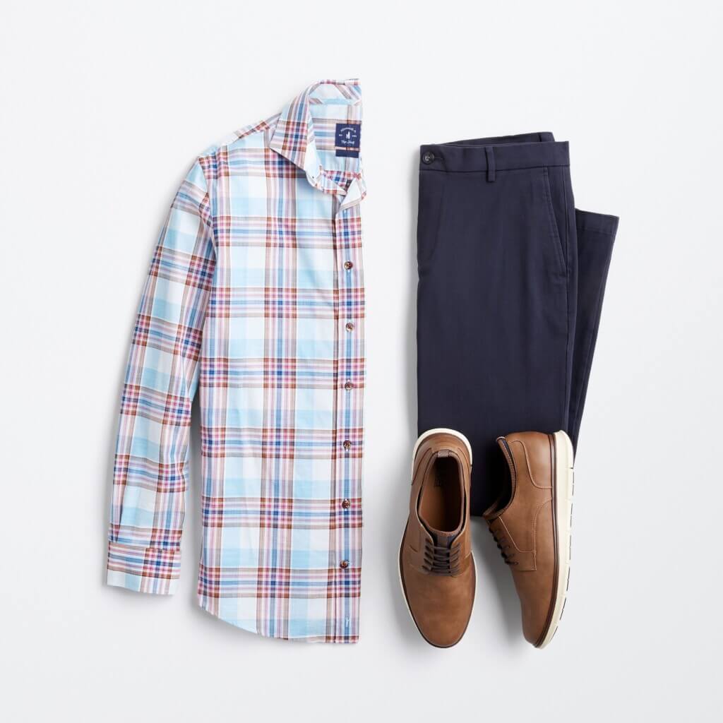 Stitch Fix men’s fall shoe outfit with long-sleeve plaid button-down, navy trousers and brown shoes.
